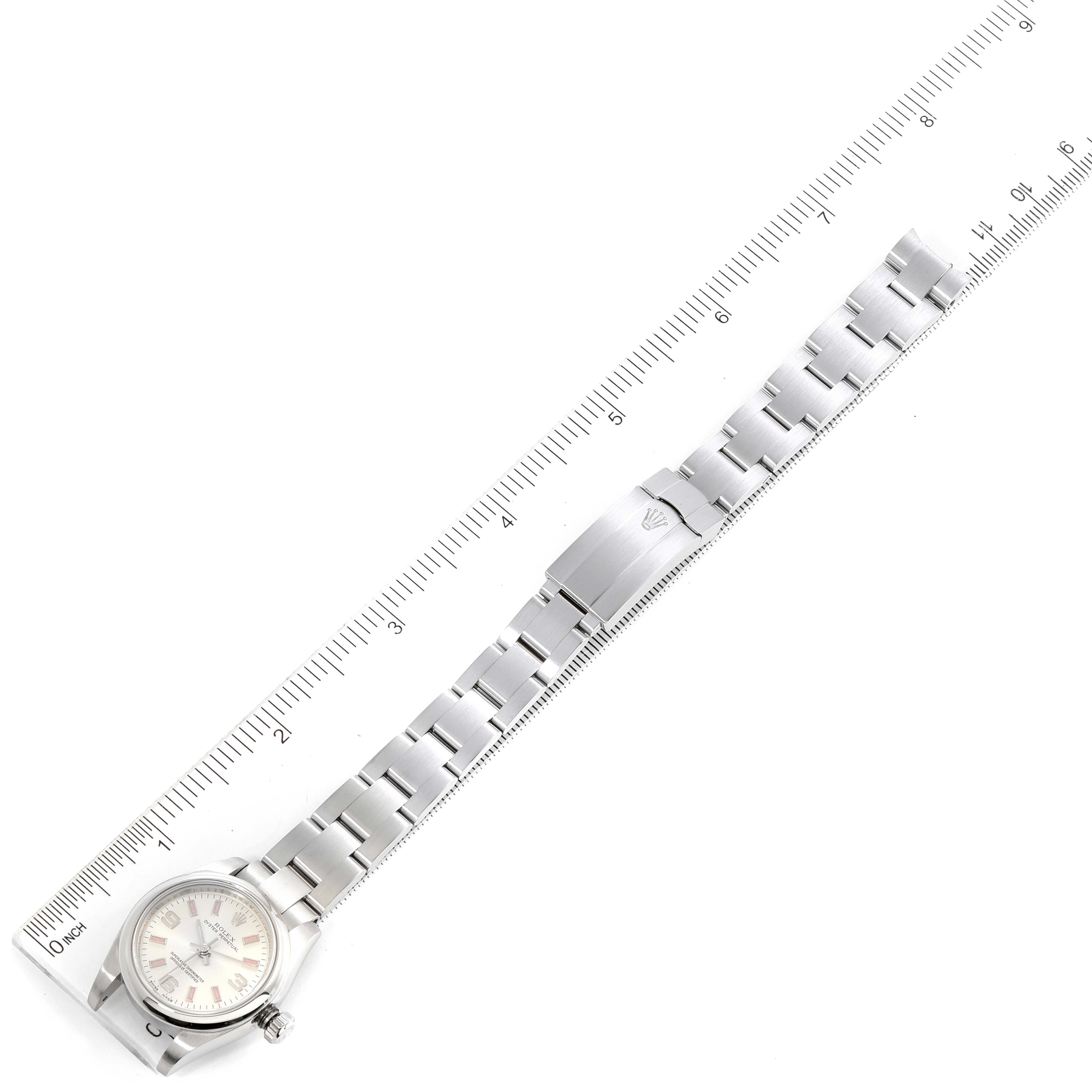 This image shows an overhead view of a Rolex Oyster Perpetual 176200 Women's Stainless Steel Silver Dial 176200 Women's Stainless Steel Silver Dial watch with a ruler for scale.