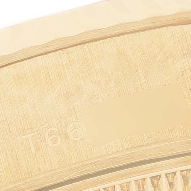 The image shows a close-up of the side edge of a Rolex President 69278 Women's Yellow Gold White Dial model, highlighting engraved details.