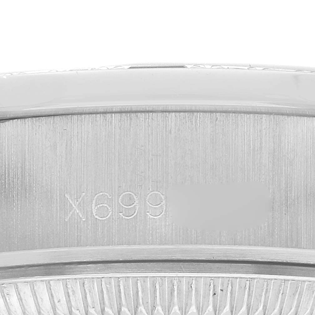 The image shows an engraved portion of the inner case of a Rolex President 69069 Women's White Gold Silver Dial watch at a close-up angle.