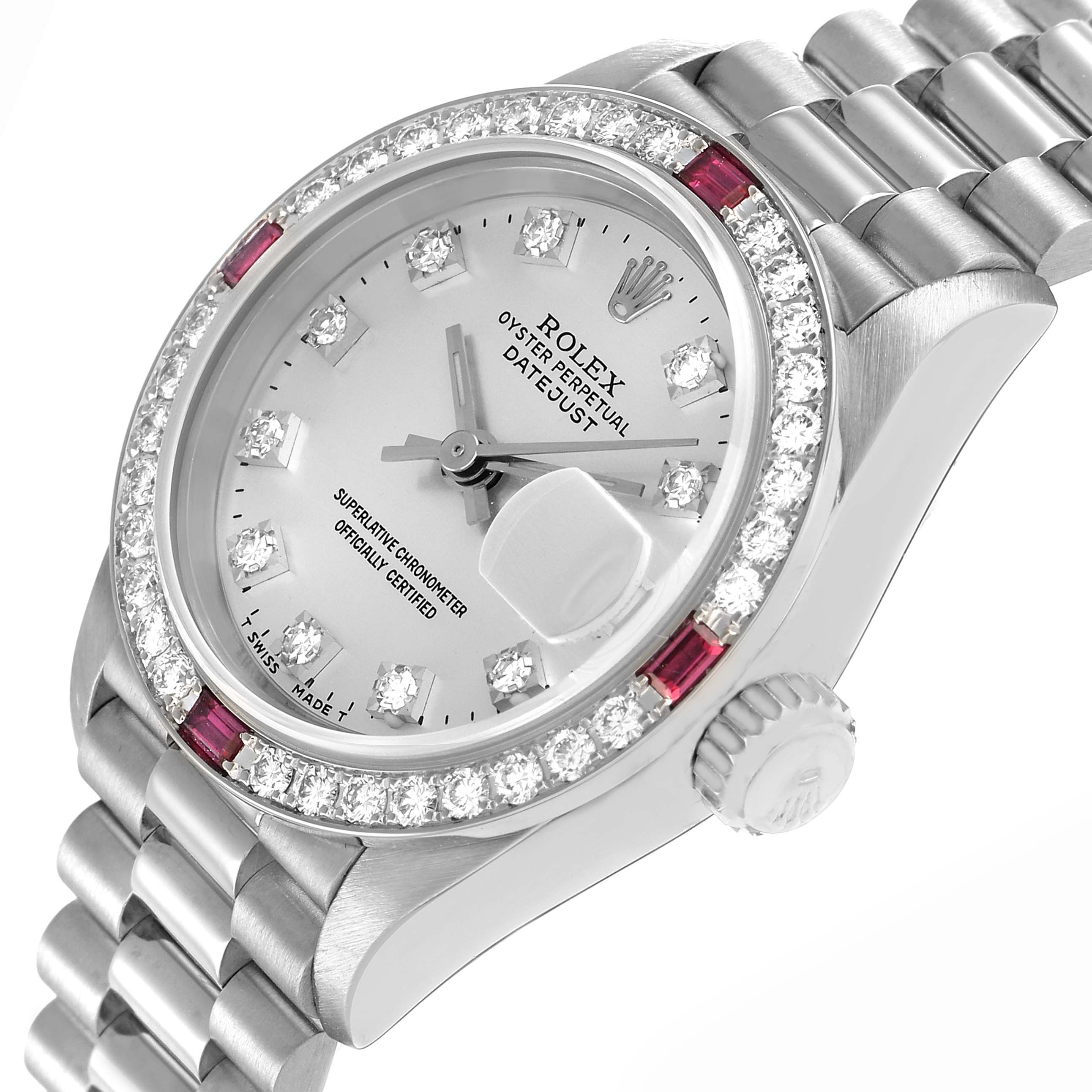 The Rolex President 69069 Women's White Gold Silver Dial model watch is shown at an angled view, highlighting the bezel with diamonds and rubies, dial, and part of the bracelet.