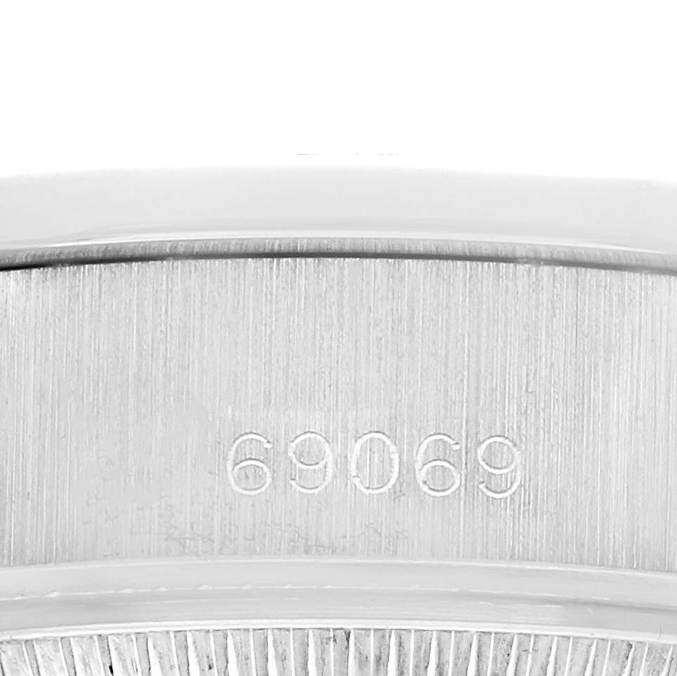 The image shows a close-up of the serial number on the case of a Rolex President 69069 Women's White Gold Silver Dial model.
