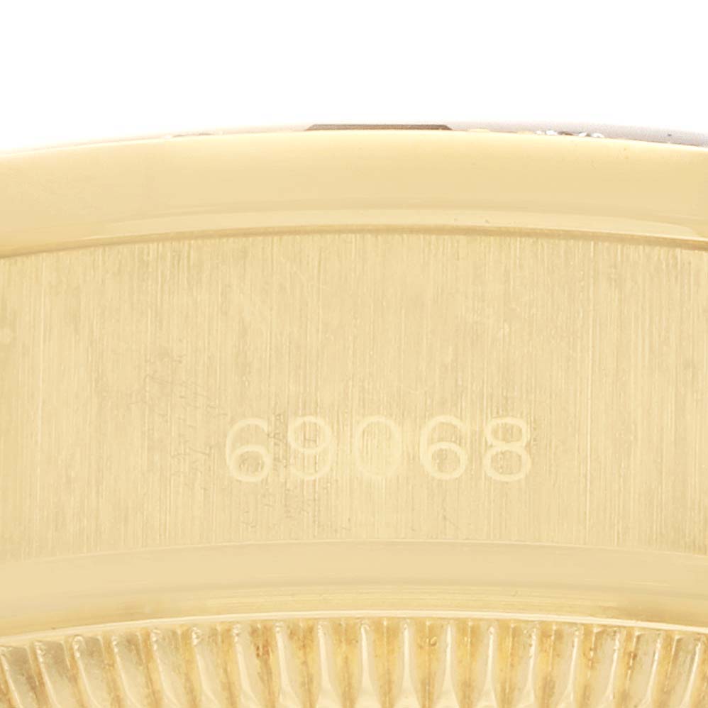 The image shows a close-up of the case back and part of the bezel of a Rolex President 69068 Women
s Yellow Gold Champagne Dial watch, highlighting the model number.