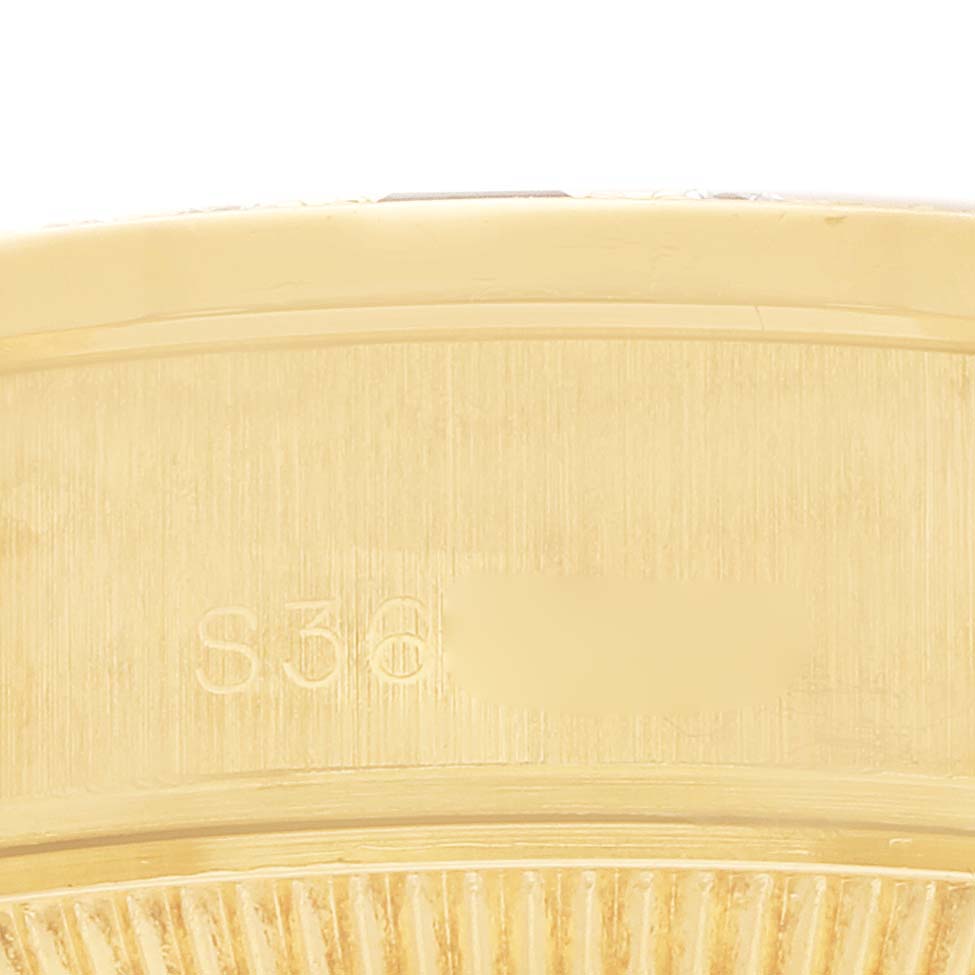 This image shows the edge and serial number of a Rolex President 69068 Women
s Yellow Gold Champagne Dial model watch.