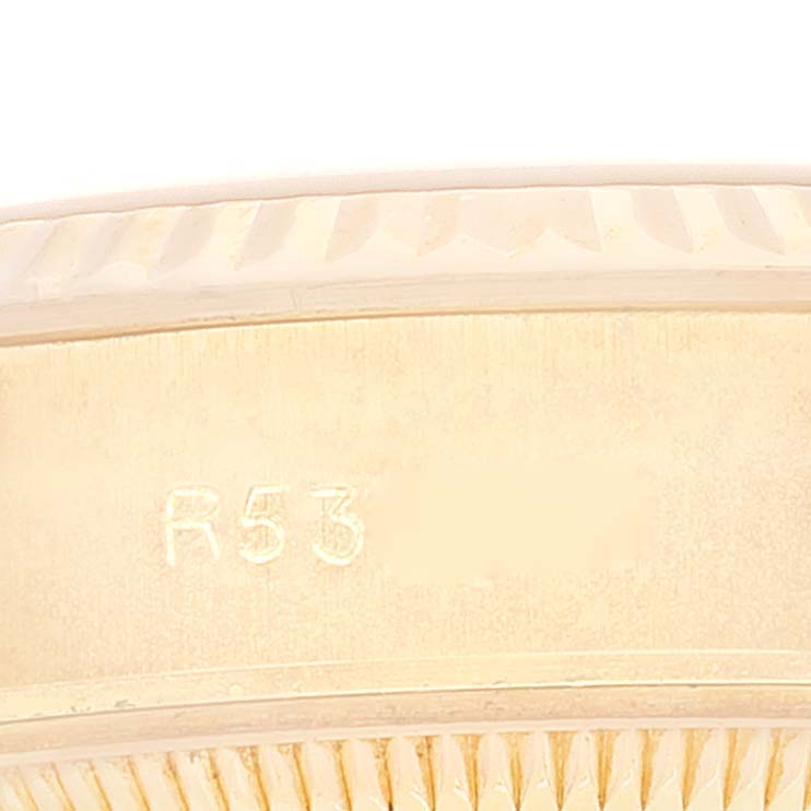 This image shows a close-up of the bezel and possibly the engraved reference number "R53" on the President model by Rolex.