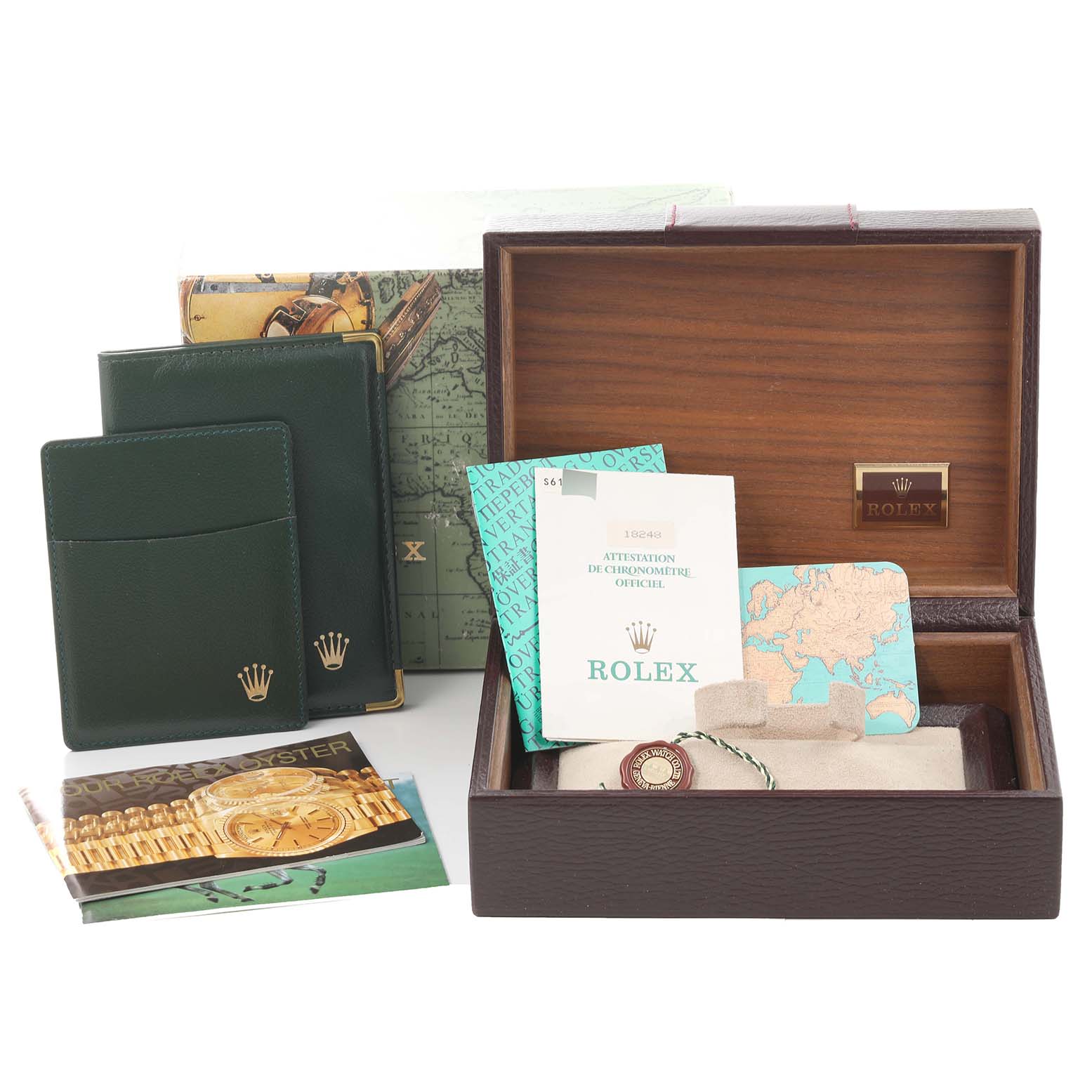 The image displays the accessories of a Rolex President 18248 Men's Yellow Gold Champagne Dial 18248 Men's Yellow Gold Champagne Dial model, including a box, booklets, cardholders, and tags.