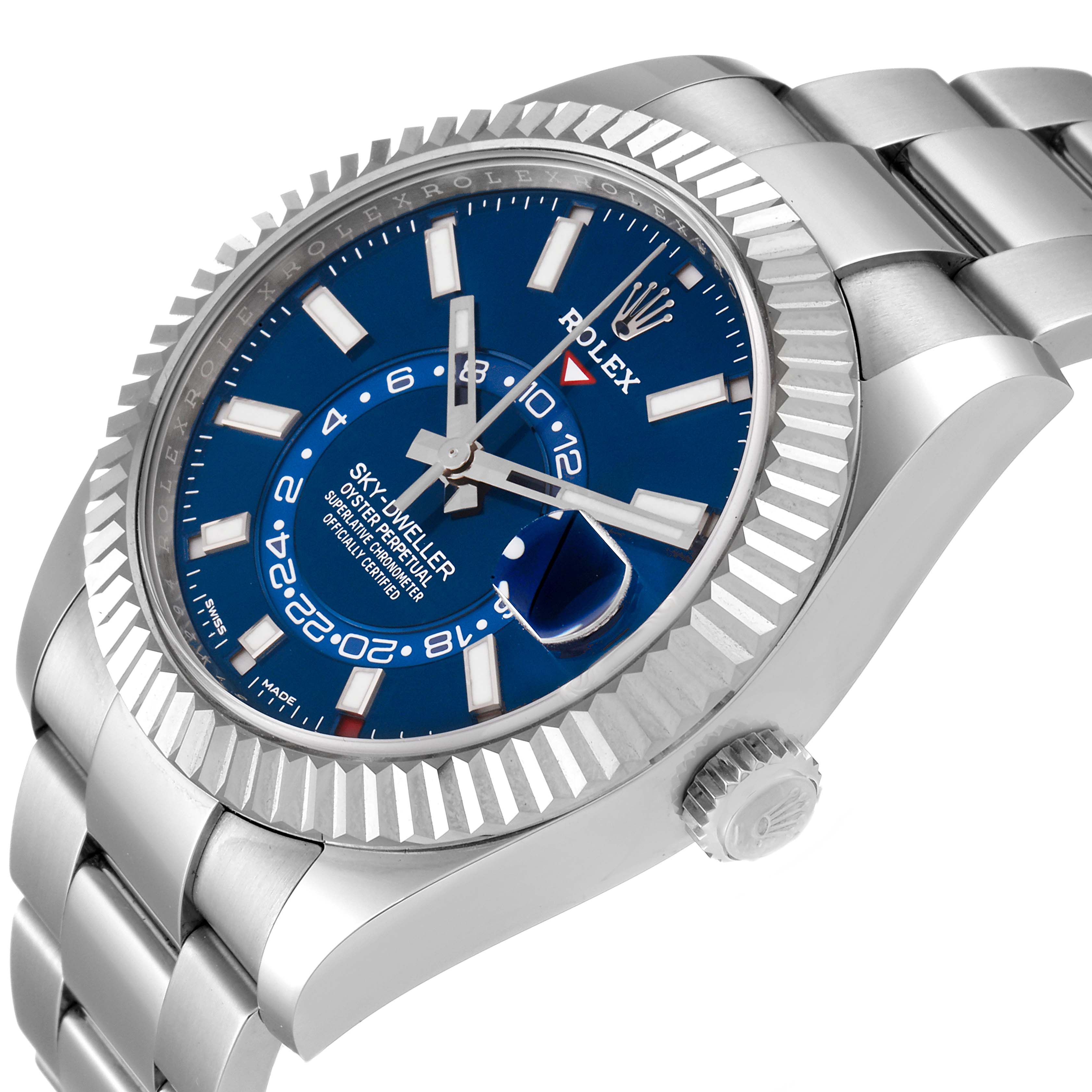 The image shows a Rolex Sky-Dweller 326934 Men's Stainless Steel Blue Dial 326934 Men's Stainless Steel Blue Dial watch from a three-quarter angle, highlighting its blue dial, fluted bezel, crown, and metal bracelet.