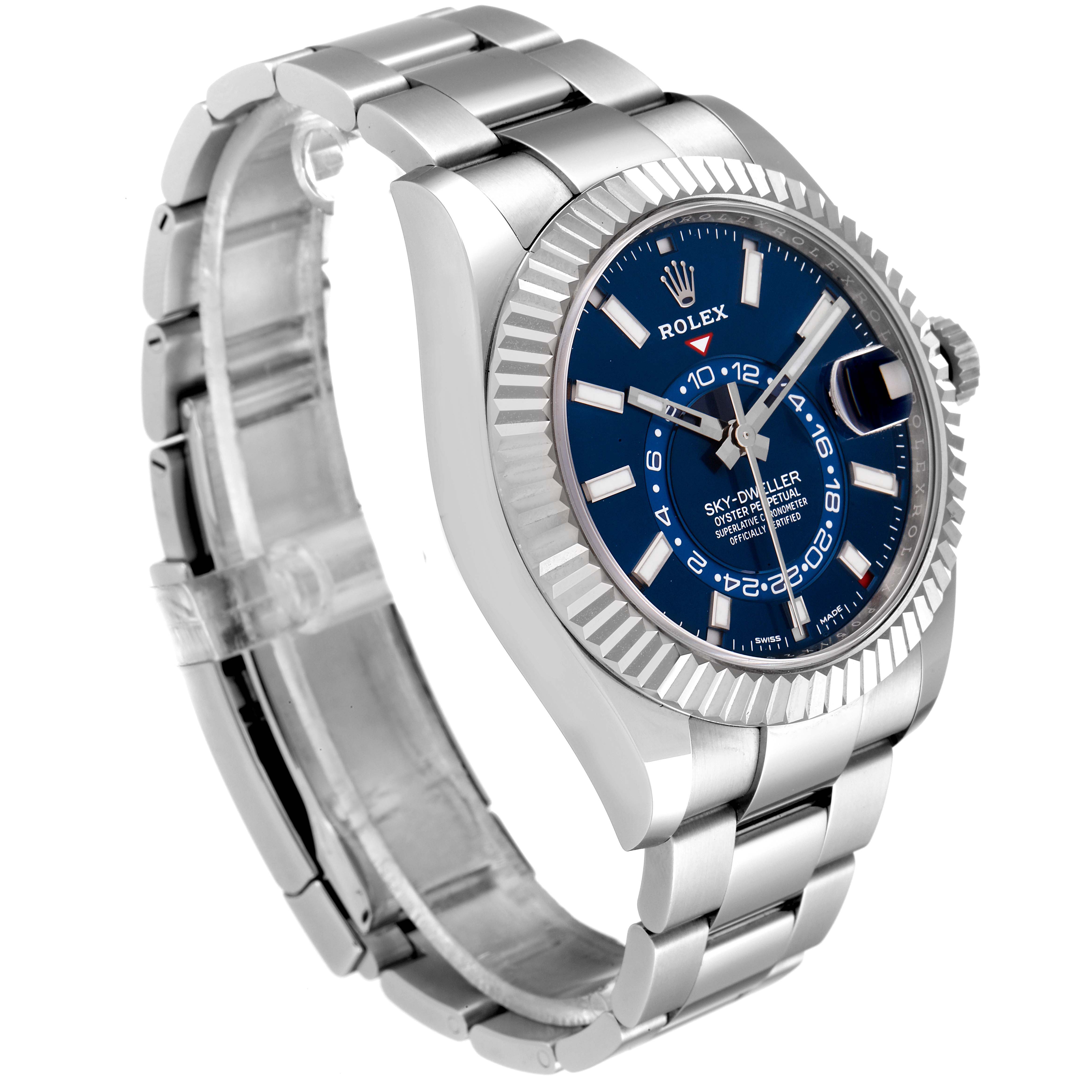 The image shows a Rolex Sky-Dweller 326934 Men's Stainless Steel Blue Dial 326934 Men's Stainless Steel Blue Dial watch at a three-quarter angle, highlighting the blue dial, fluted bezel, and metal bracelet.