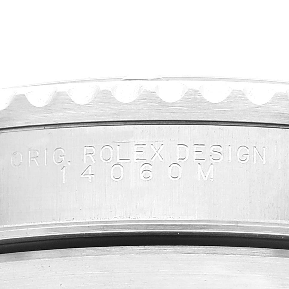 This image shows a close-up view of the engraved reference number and bezel edge on the Rolex Submariner 14060M Men
s Stainless Steel Black Dial 14060M Men
s Stainless Steel Black Dial watch.