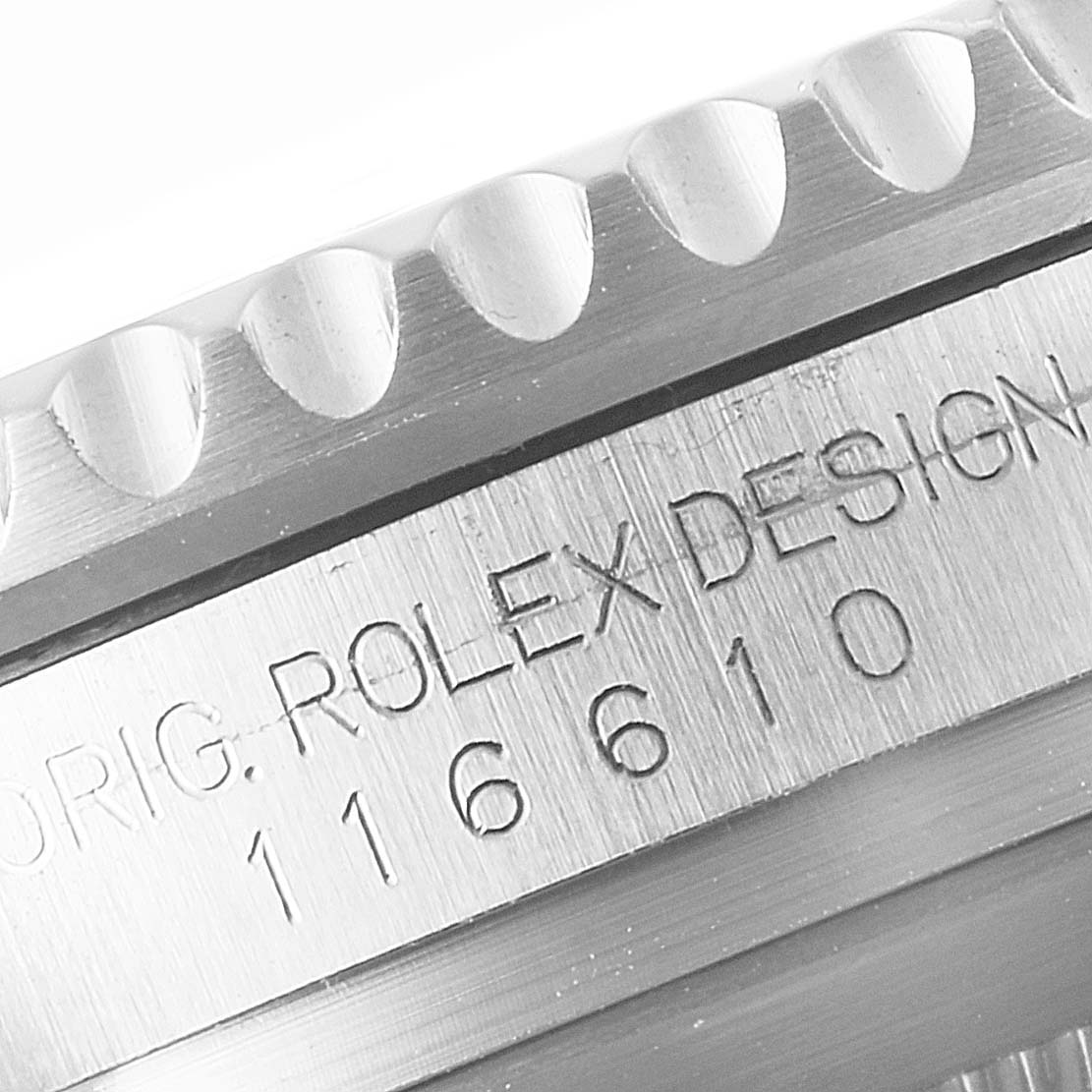 The image shows a close-up angle of the bezel and engraved inner case of a Rolex Submariner 116610LV Men
s Stainless Steel Green Dial 116610LV Men
s Stainless Steel Green Dial watch, model 116610.
