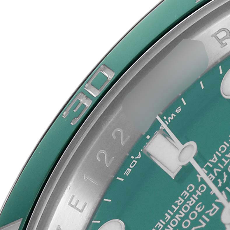 The image shows a close-up of the bezel and dial edge of a Rolex Submariner 116610LV Men
s Stainless Steel Green Dial, focusing on the "90" marker and part of the dial text.