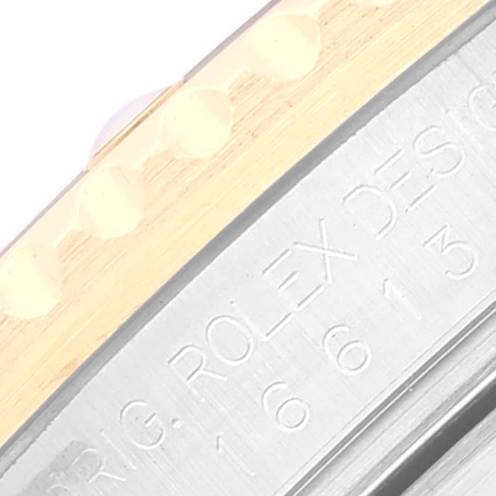 This image shows a close-up angle of the bezel and engraved side of the Rolex Submariner 16613 Men's Steel and Gold (two tone) Black Dial 16613 Men's Steel and Gold (two tone) Black Dial watch.