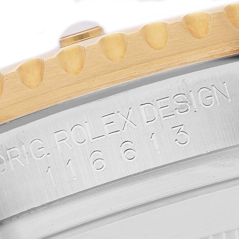 The image shows the side view of a Rolex Submariner 116613LB Men's Steel and Gold (two tone) Blue Dial, focusing on its engraved model number and the gold edge of the bezel.