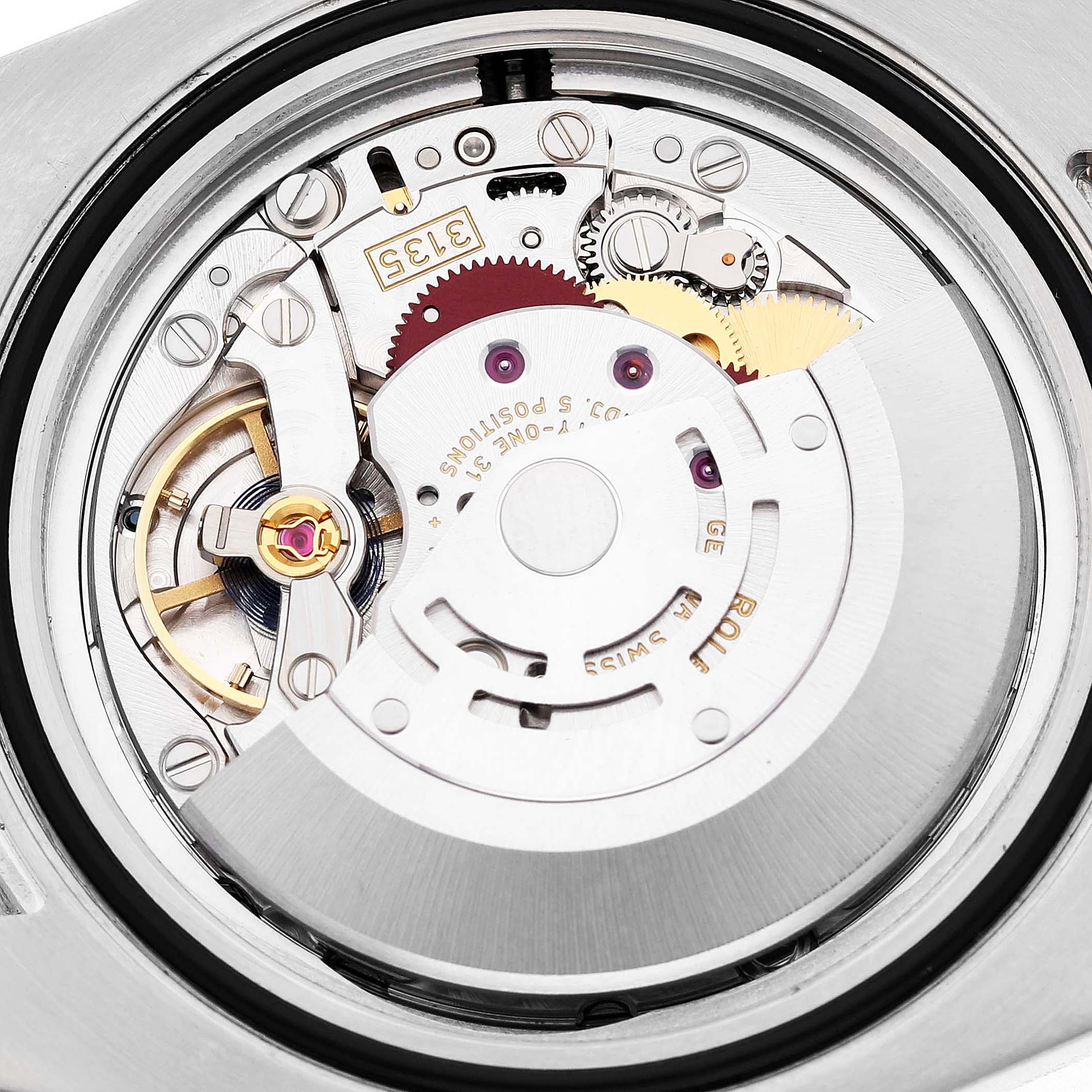 The image shows the Rolex Submariner 116613LB Men's Steel and Gold (two tone) Blue Dial watch movement, focusing on the intricate mechanical components and rotor.