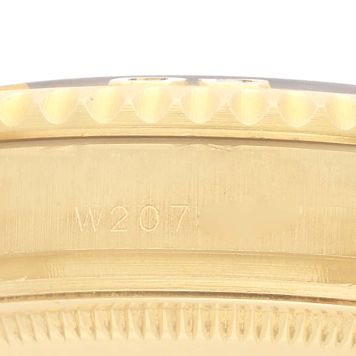 The image shows a close-up of the side of the Rolex Yacht-Master 68628 Men
s Yellow Gold White Dial, focusing on the case with visible serial engraving.