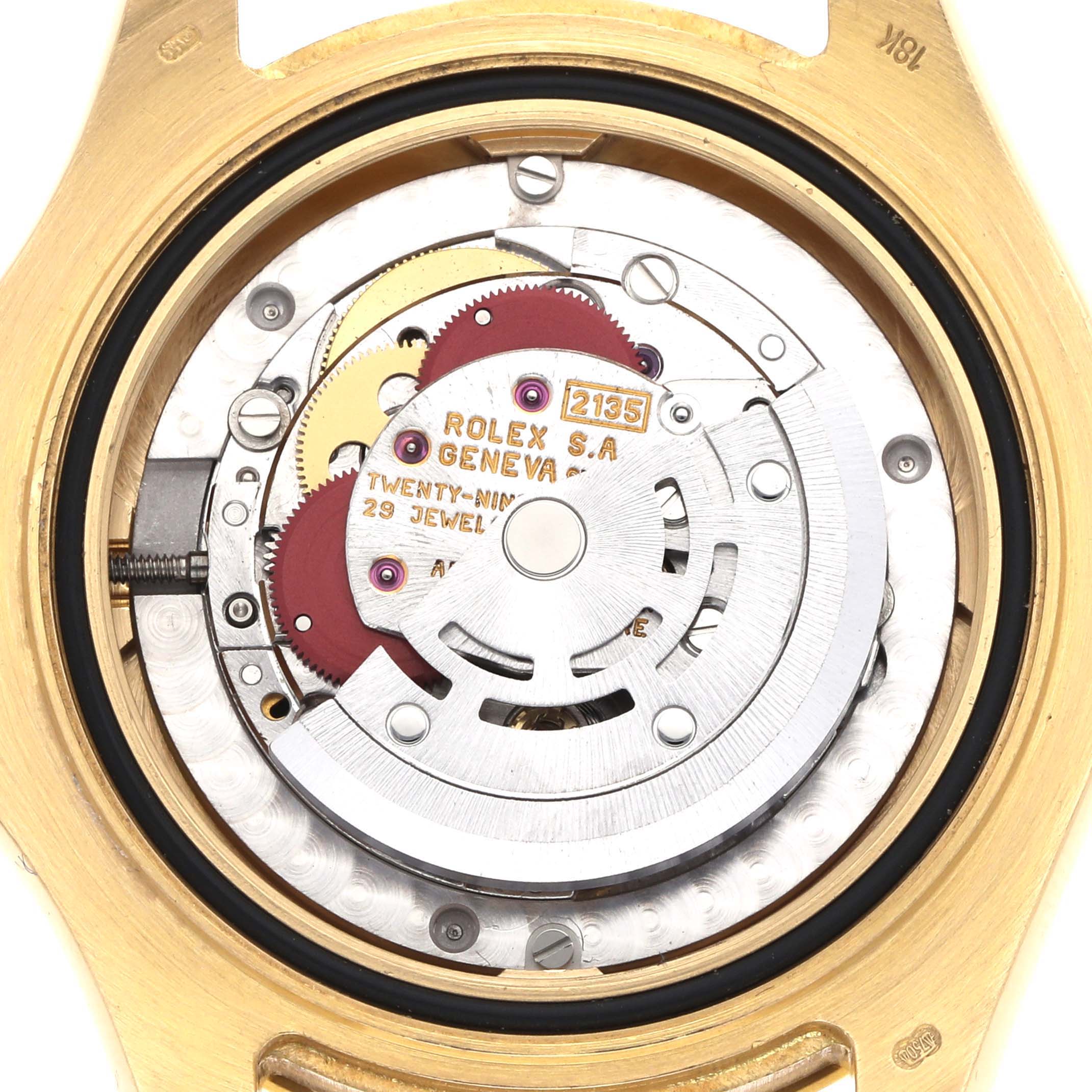 The image shows the movement mechanism of a Rolex Yacht-Master 68628 Men
s Yellow Gold White Dial watch from a top-down angle, highlighting gears and jewels.
