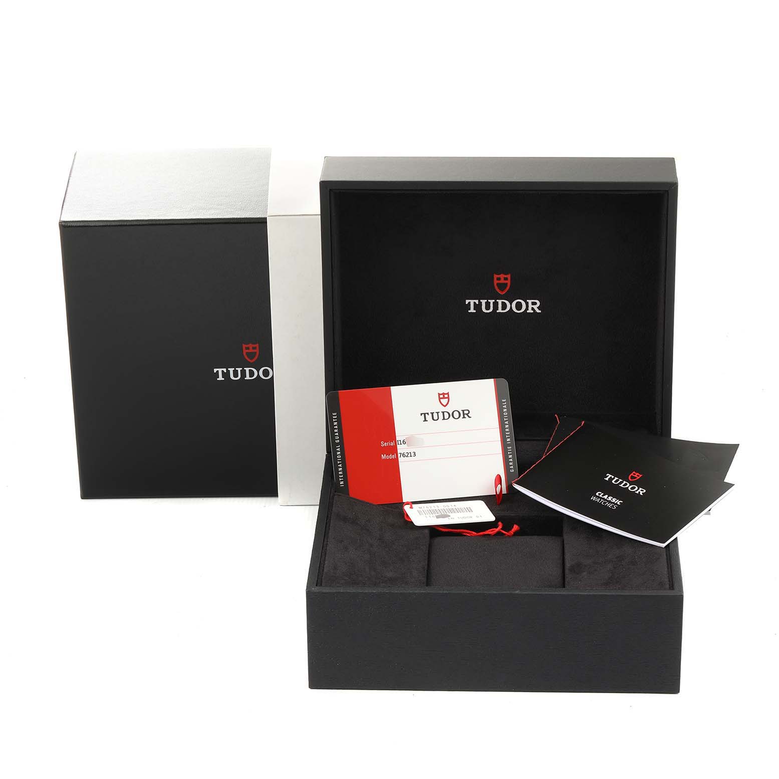The image shows the open box, warranty card, and booklet for the Prince model by Tudor.