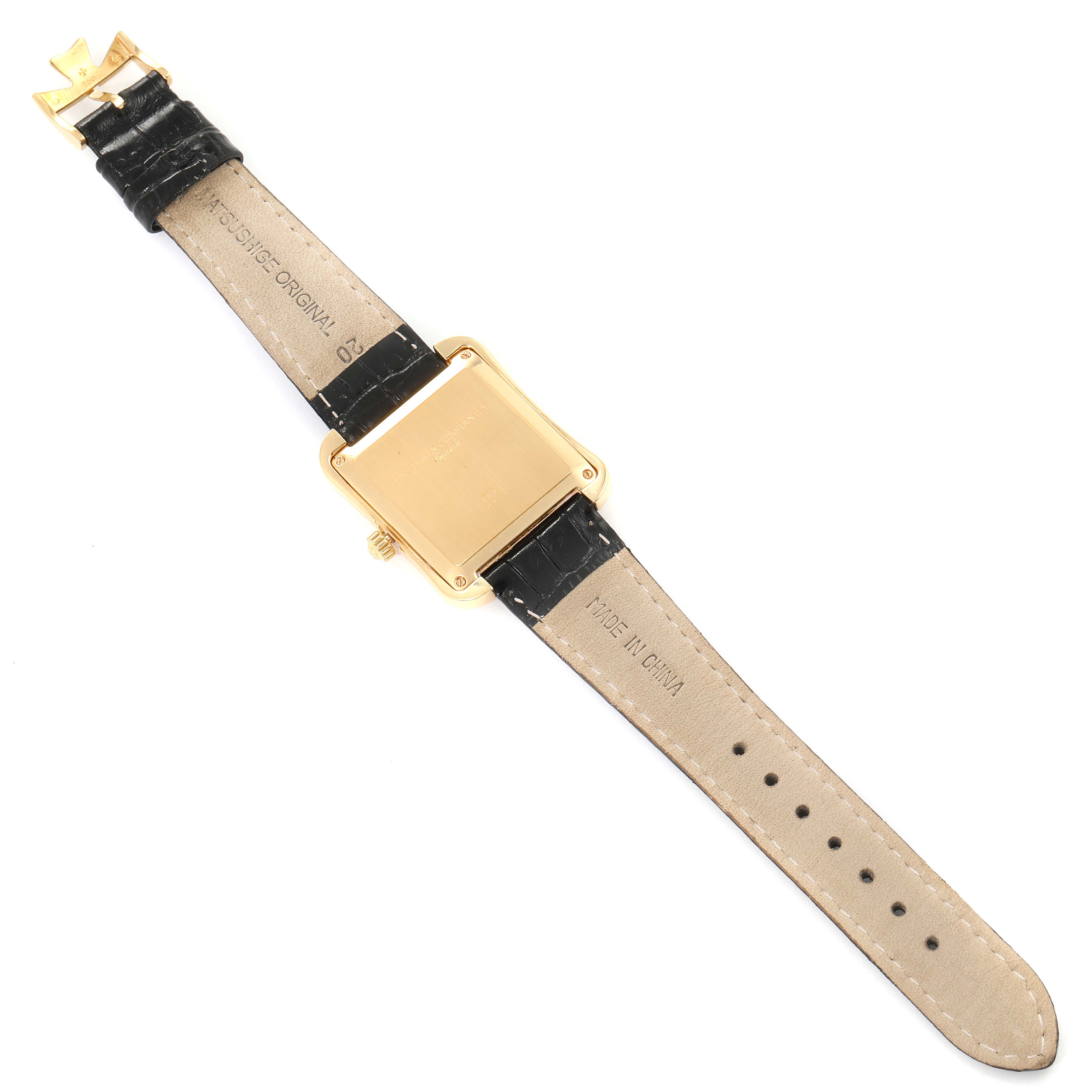 The image shows the back view of a Vacheron Constantin Historiques 42100 Men's Yellow Gold Silver Dial 42100 Men's Yellow Gold Silver Dial model watch with a square gold case and leather strap.