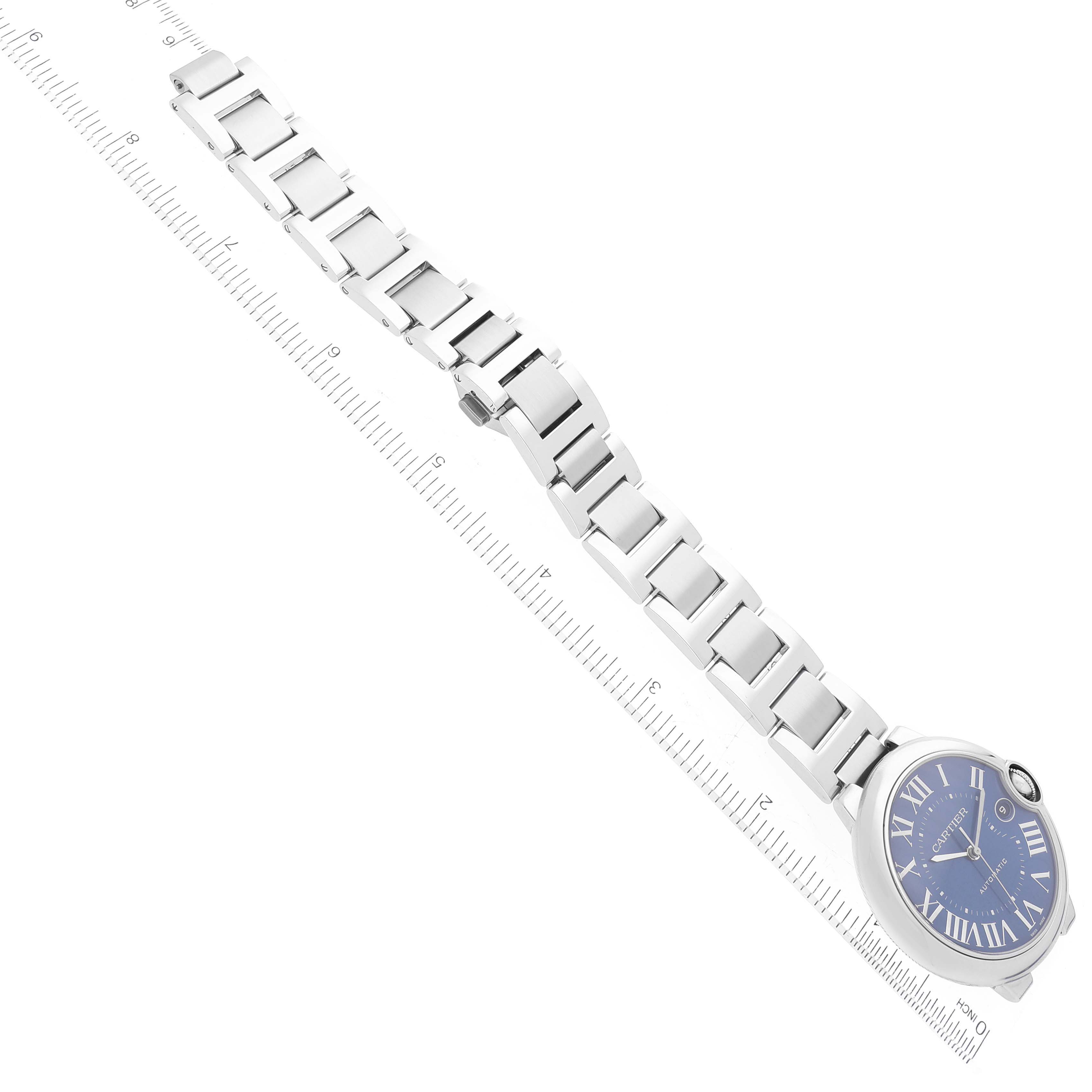 The image shows a Ballon Bleu model by Cartier watch with its face and full bracelet, displayed diagonally with a ruler for scale.
