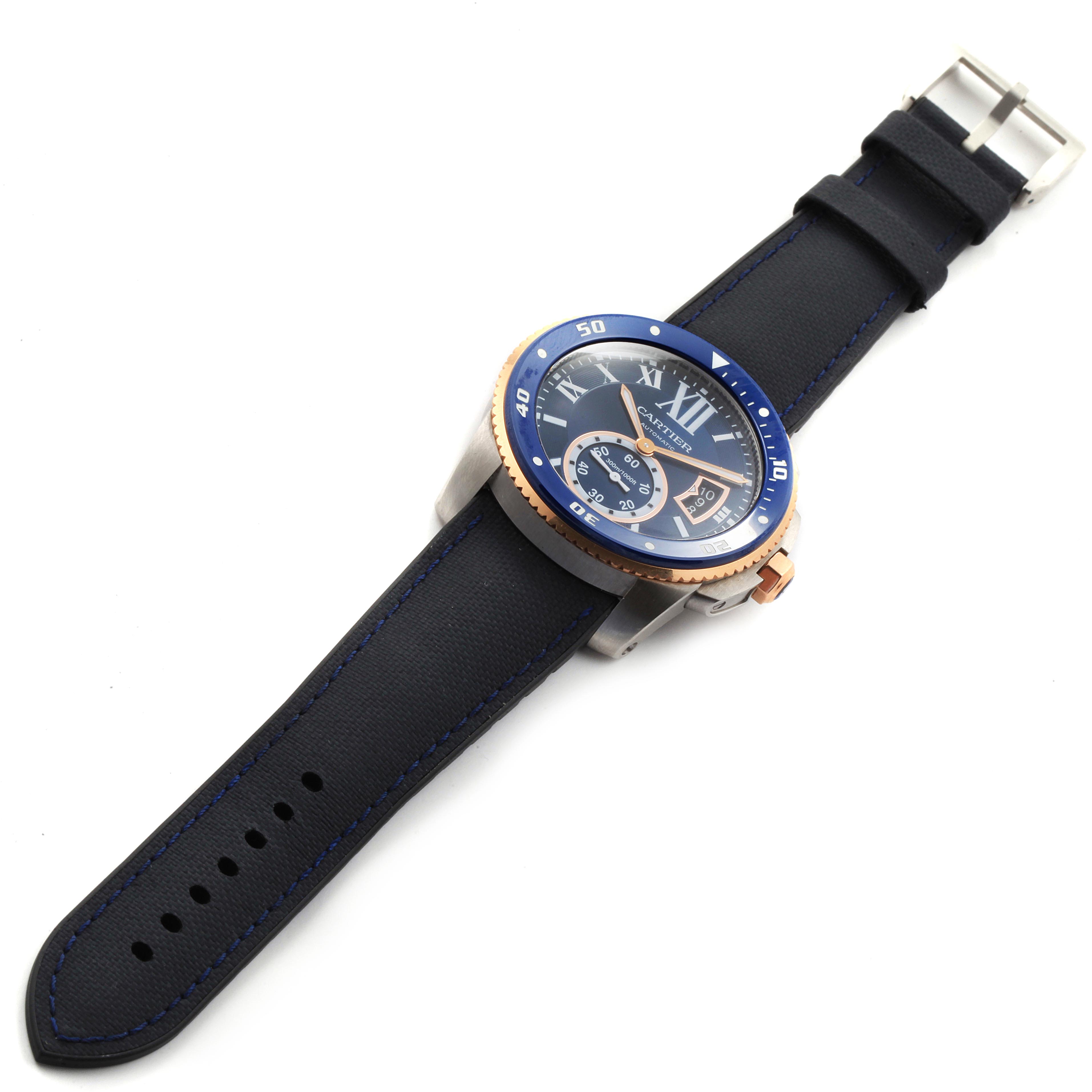 The image shows a Calibre de Cartier watch by Cartier from an angled top view, highlighting the face, strap, and buckle.