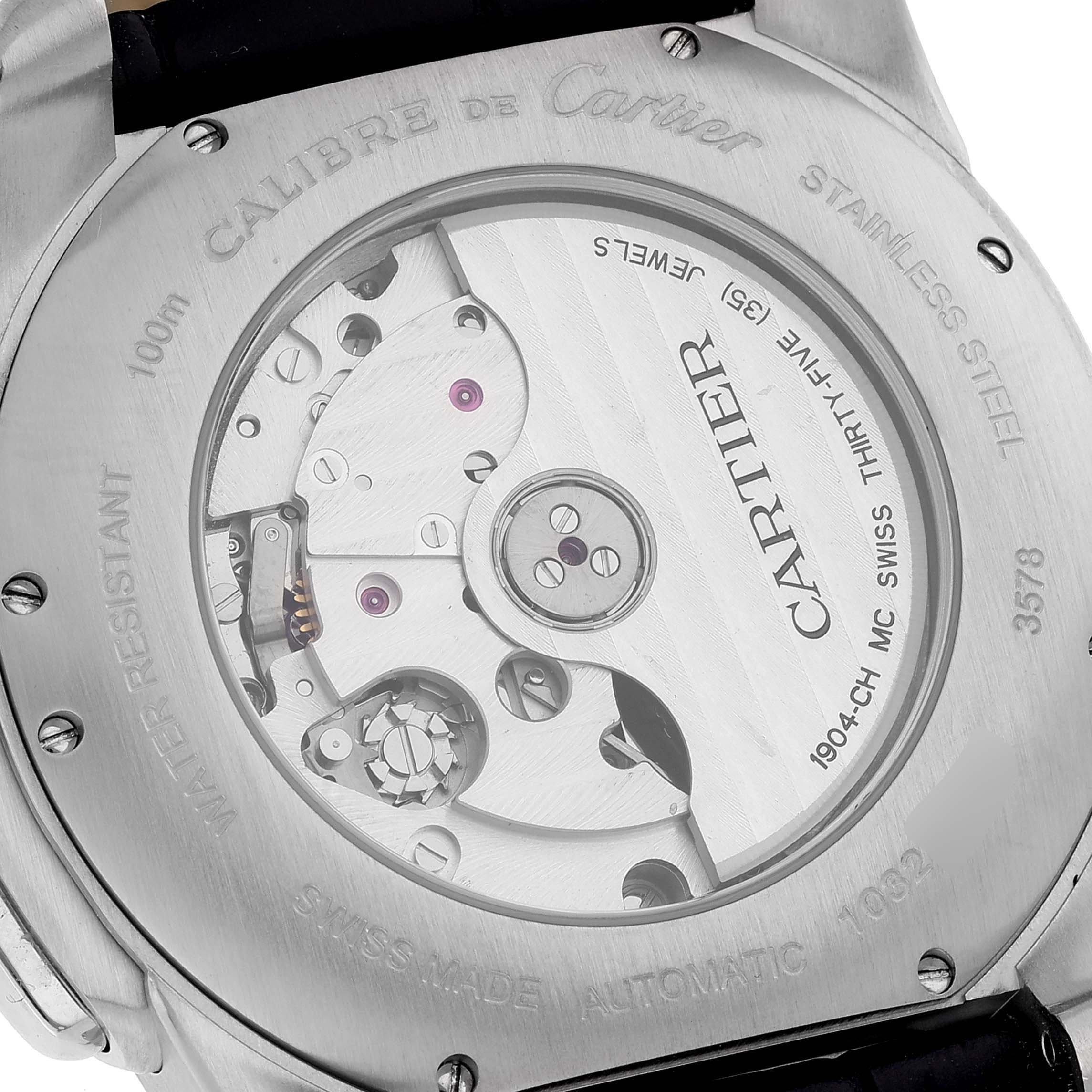 The image shows the back of a Calibre de Cartier watch by Cartier, highlighting its mechanical movement.