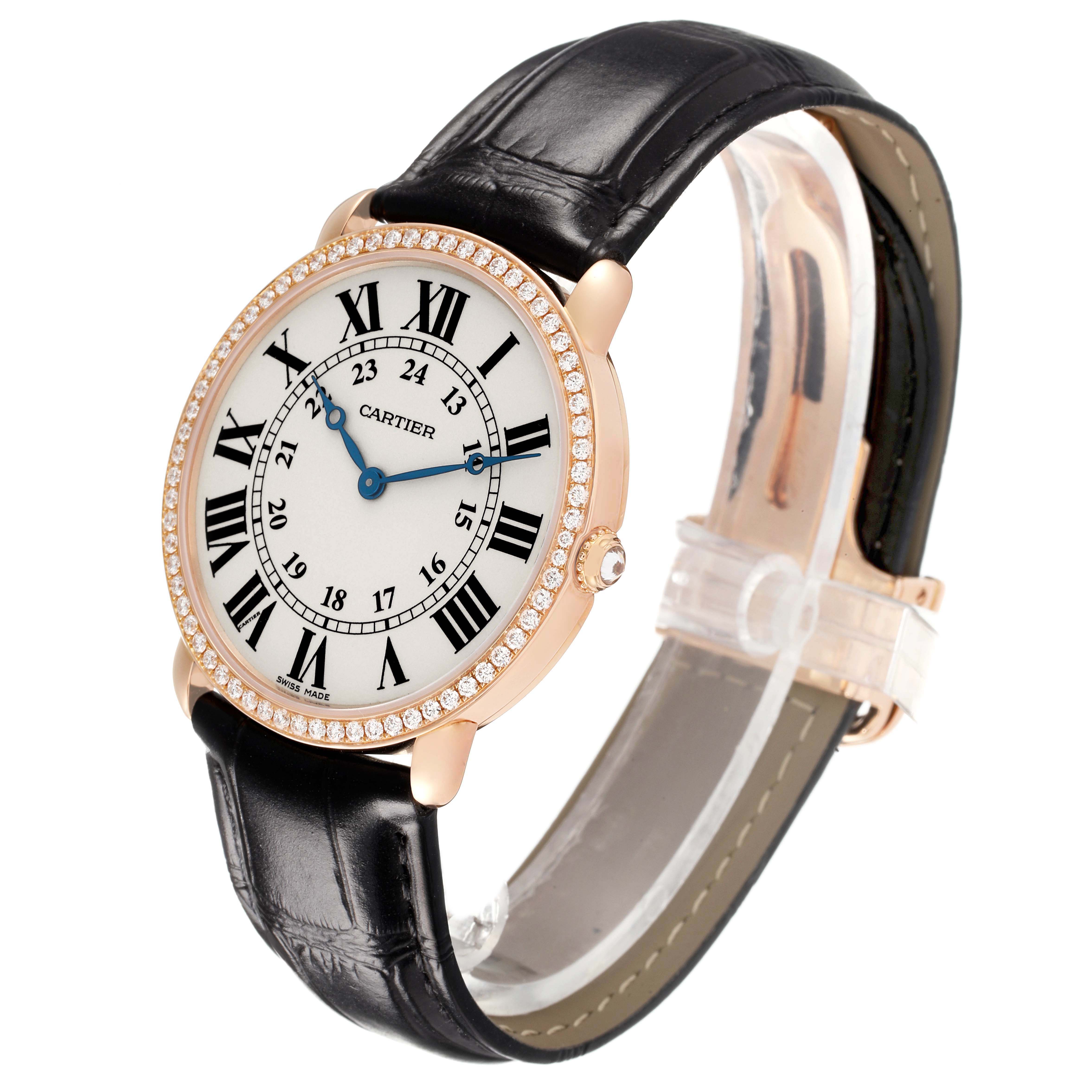 The Cartier Tank Louis WR000651 Women's Rose Gold Silver Dial watch is shown at a slight angle, displaying the round face, Roman numerals, bejeweled bezel, and black leather strap.