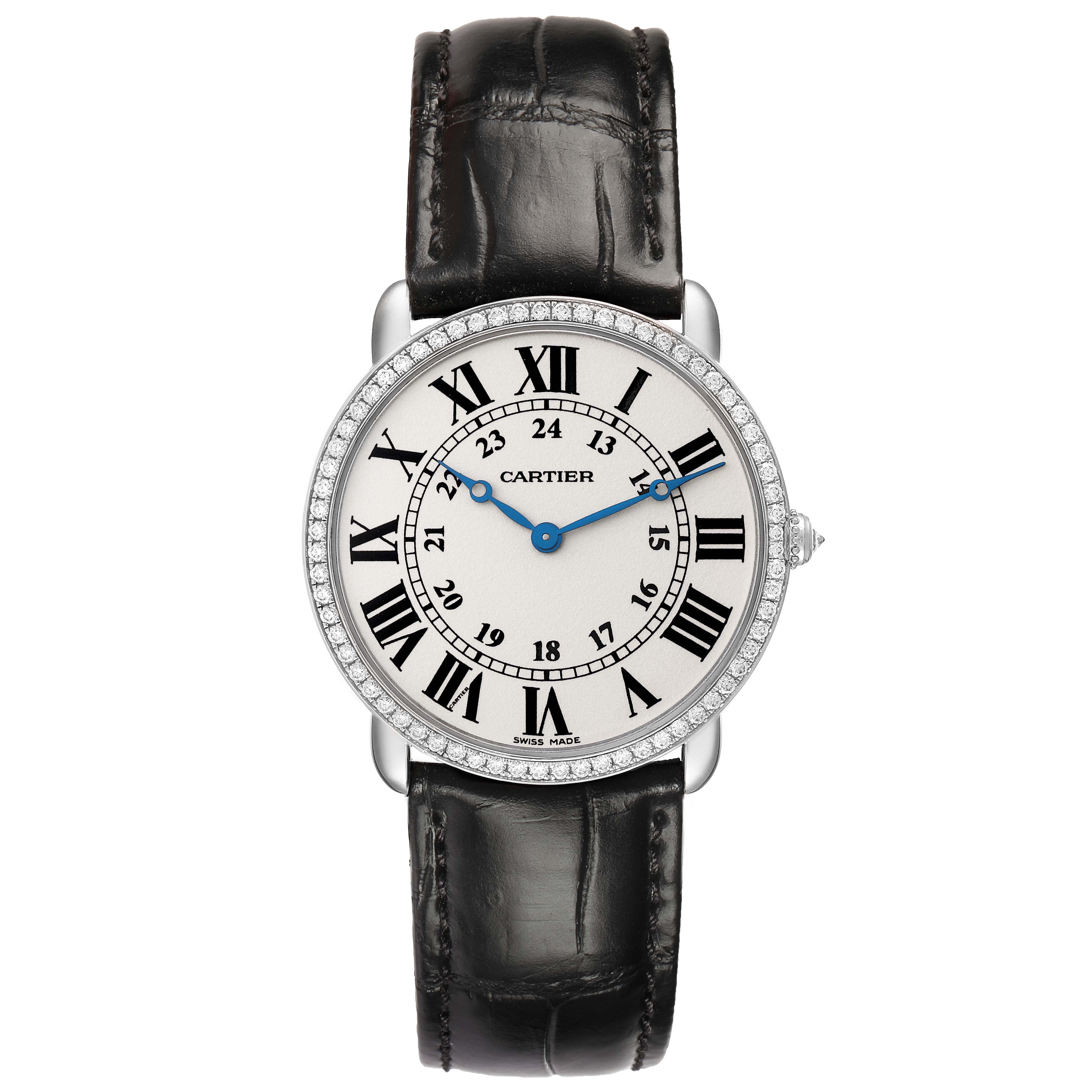 The Cartier Ronde WR000551 Women's White Gold Silver Dial watch is shown from a front angle, displaying its face, Roman numerals, blue hands, and black leather strap.