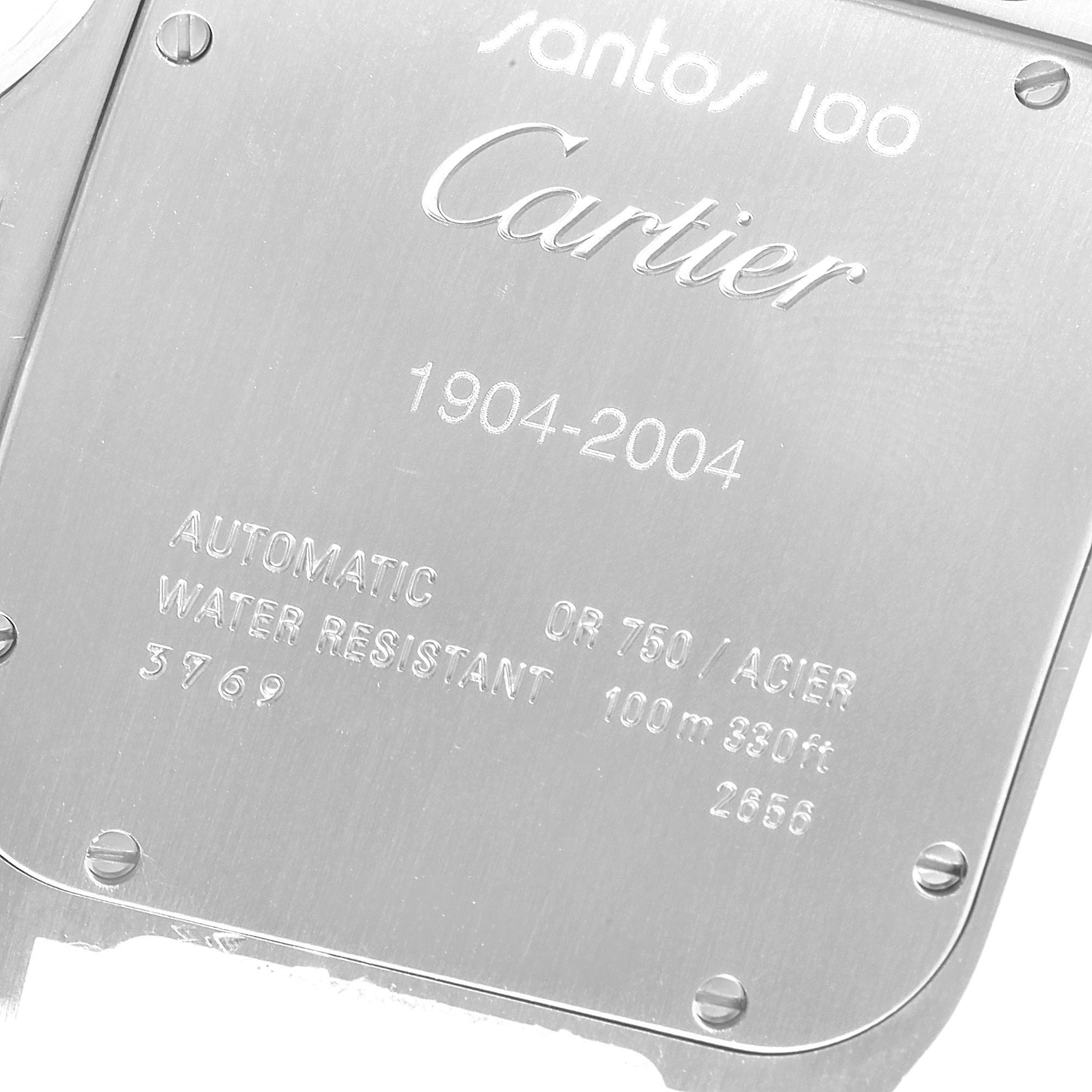 The image shows the back case of a Cartier Santos W20072X7 Men's Steel and Gold (two tone) Silver Dial W20072X7 Men's Steel and Gold (two tone) Silver Dial 100 watch, highlighting its engraving and screws.