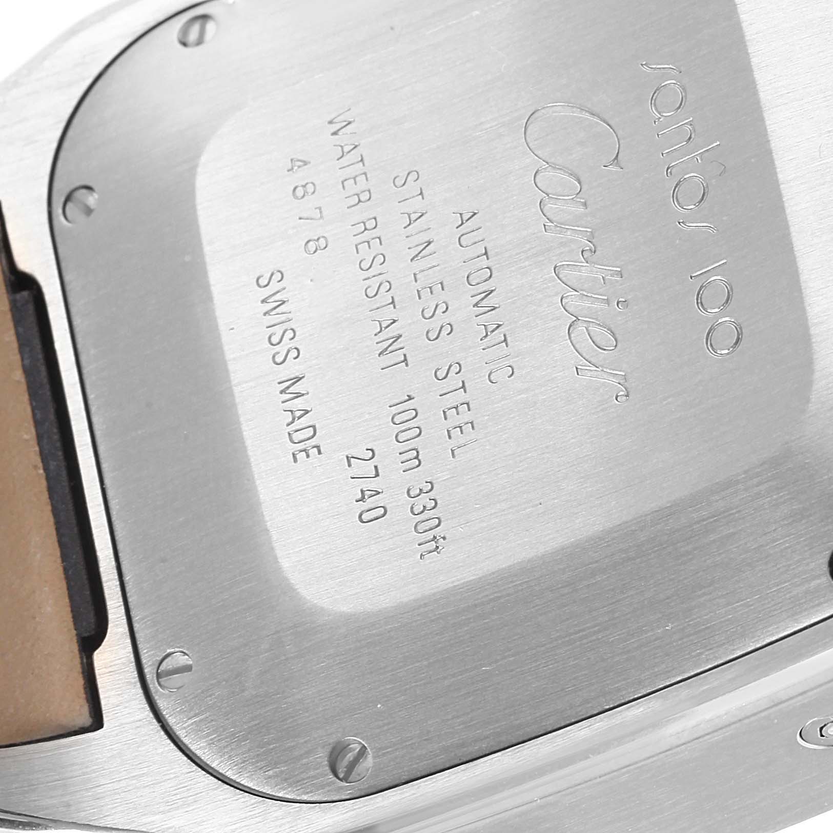 The image shows the back case of a Cartier Santos W20090X8 Men's Stainless Steel Silver Dial W20090X8 Men's Stainless Steel Silver Dial model watch, featuring an engraving with specifications.