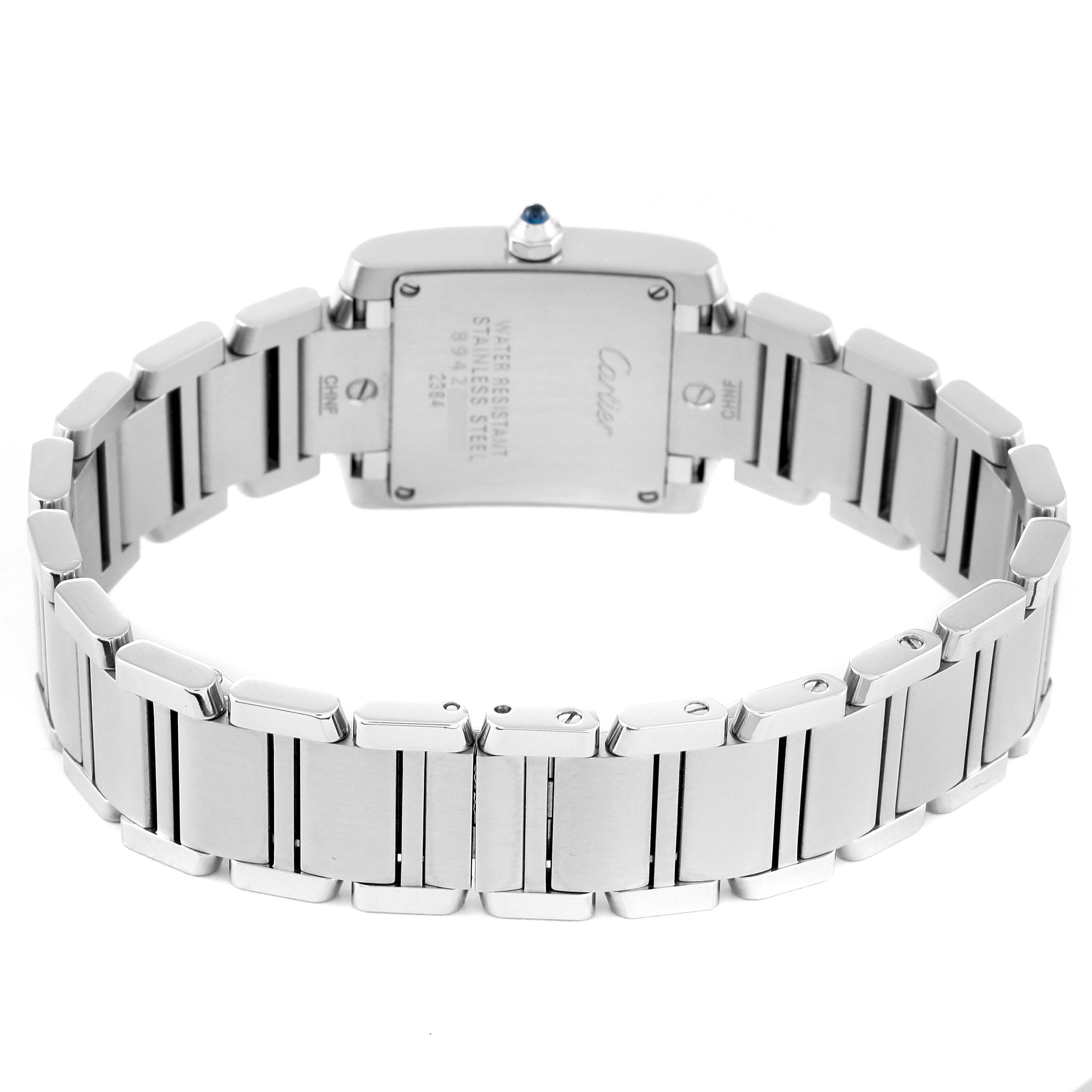 The image shows the back view of a Cartier Tank Française watch, focusing on the stainless steel strap and case back.
