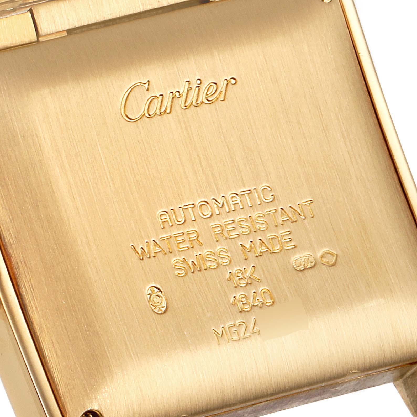 The image shows the case back of a Cartier Tank Française watch, displaying engravings with specifications.