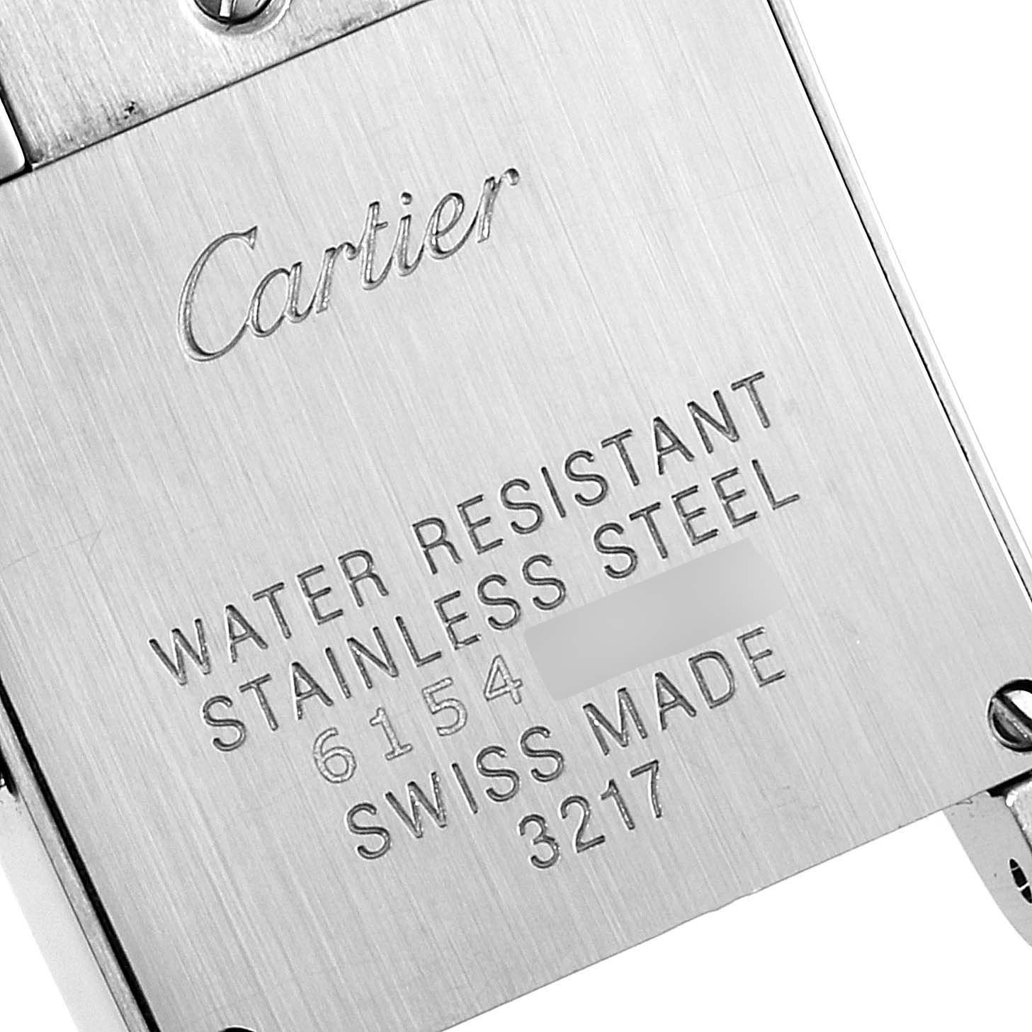 This image shows the engraved back case of a Cartier Tank Française watch, featuring model information and materials.
