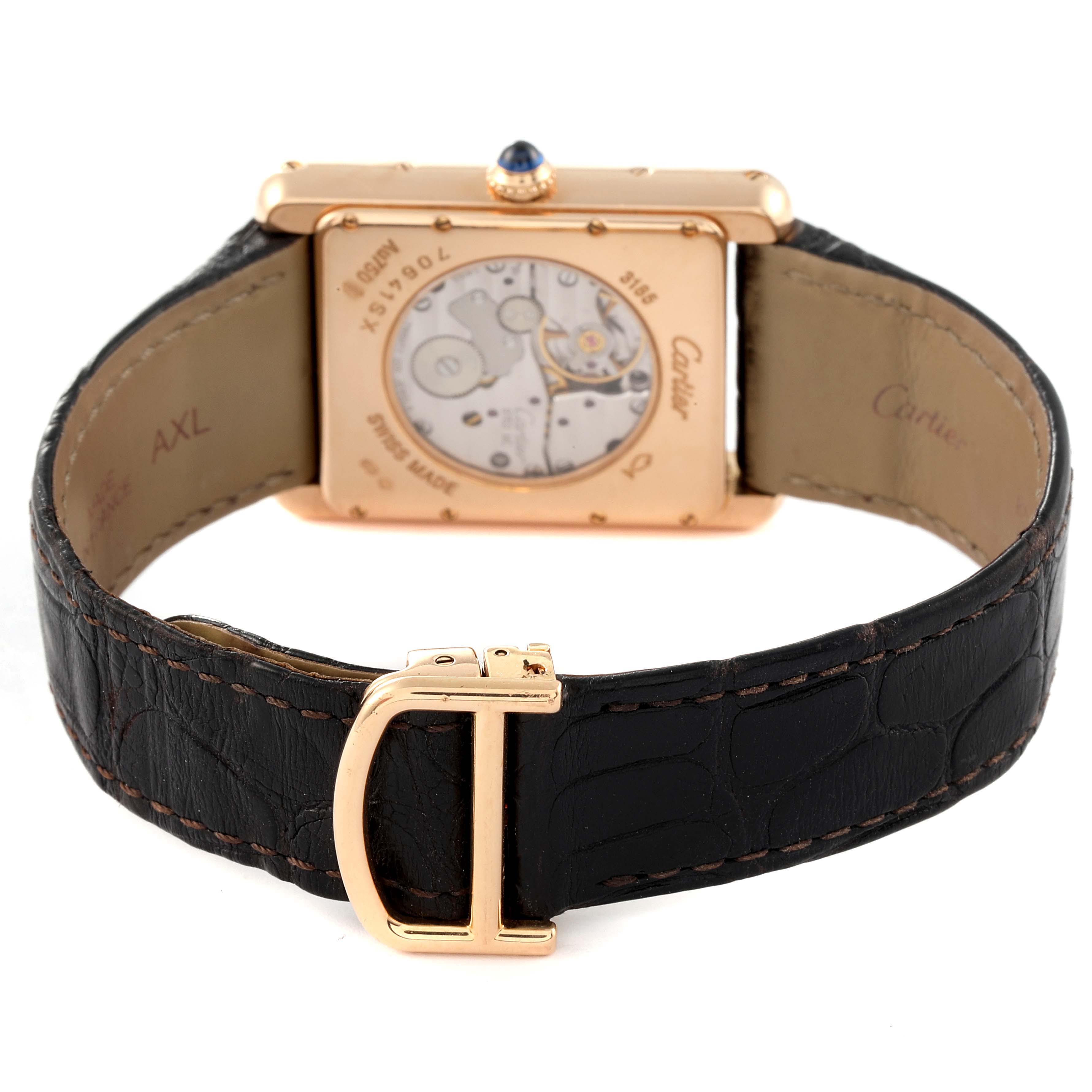 The image shows the back of the Tank Louis model by Cartier, highlighting the mechanism and leather strap.