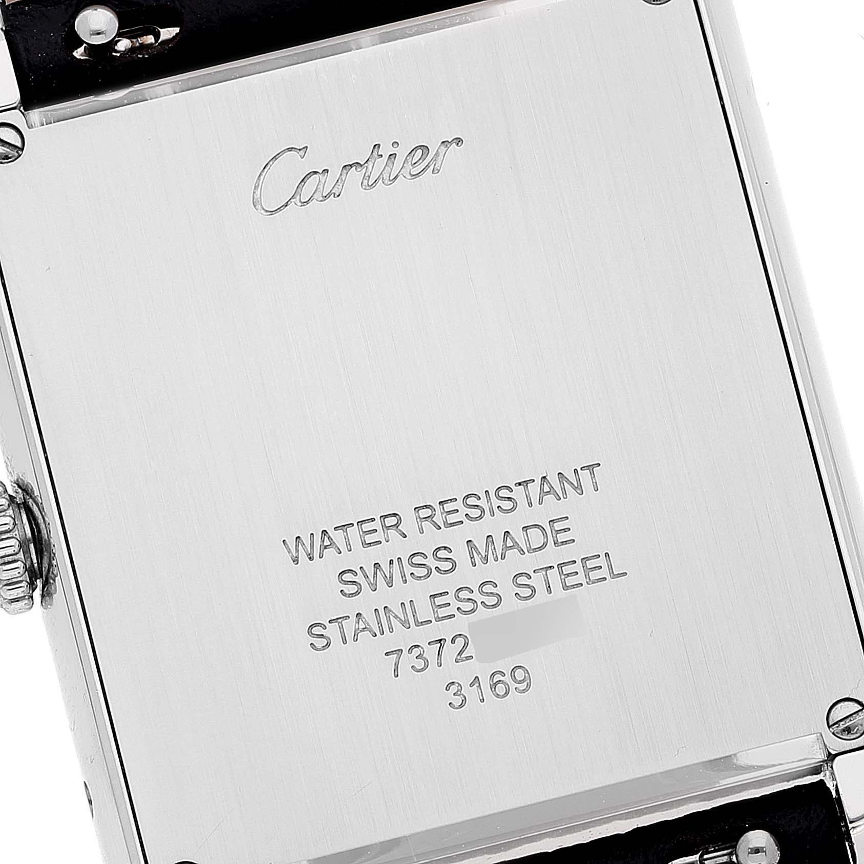 The image shows the back case of a Cartier Tank Solo WSTA0028 Men's Stainless Steel Silver Dial WSTA0028 Men's Stainless Steel Silver Dial watch, highlighting its markings and screws.