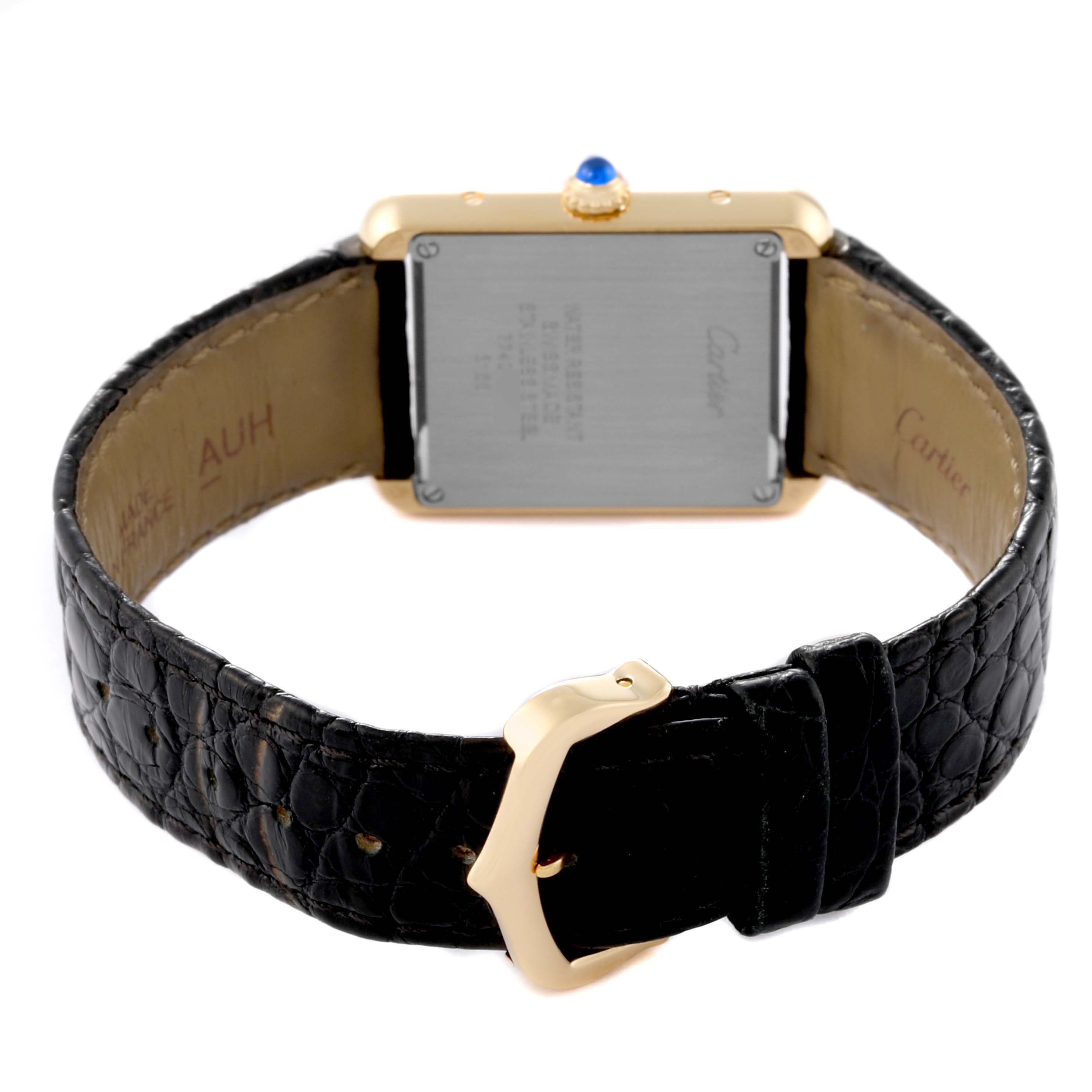 This image shows the back of a Cartier Tank Solo W5200002 Women's Steel and Gold (two tone) Silver Dial W5200002 Women's Steel and Gold (two tone) Silver Dial watch and its black leather strap with a gold buckle.