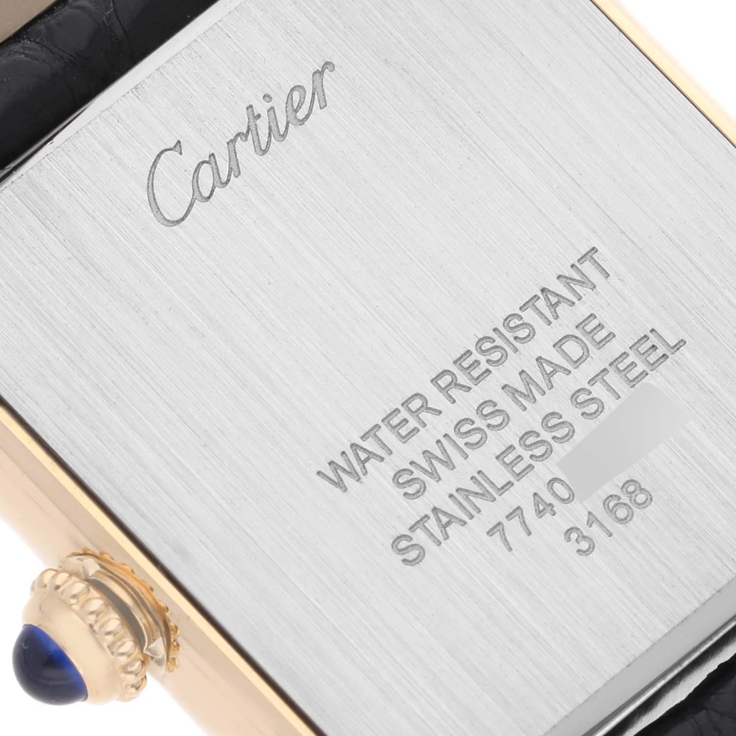 This image shows the back casing and crown of a Cartier Tank Solo W5200002 Women's Steel and Gold (two tone) Silver Dial W5200002 Women's Steel and Gold (two tone) Silver Dial watch.