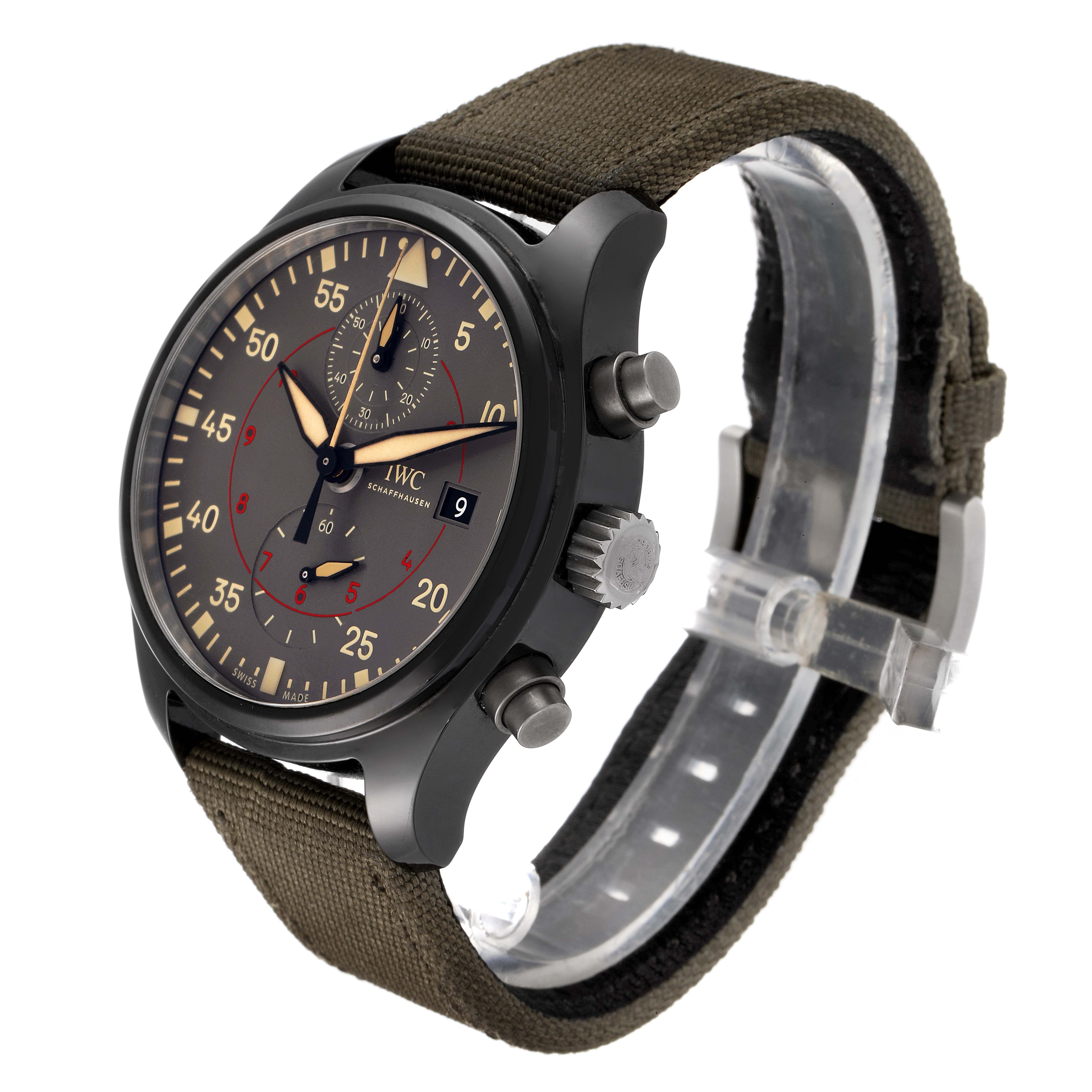 The image shows a side and front angle of the IWC Pilot IW389002 Men's Ceramic Black Dial IW389002 Men's Ceramic Black Dial model watch, displaying the face, crown, pushers, and fabric strap.