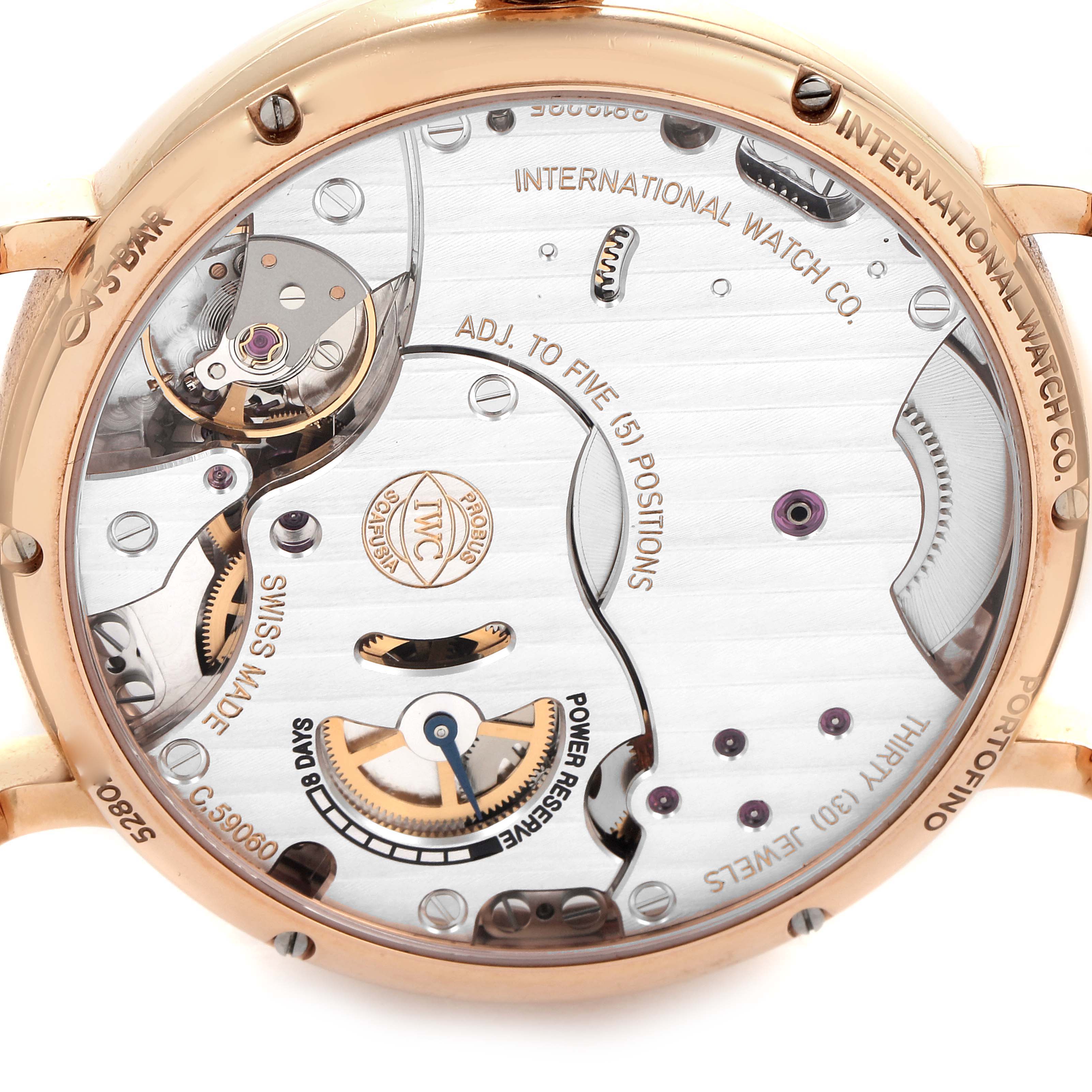 This image shows the back view of the IWC Portofino IW511101 Men's Rose Gold Silver Dial IW511101 Men's Rose Gold Silver Dial watch, displaying its intricate mechanical movement and engravings.