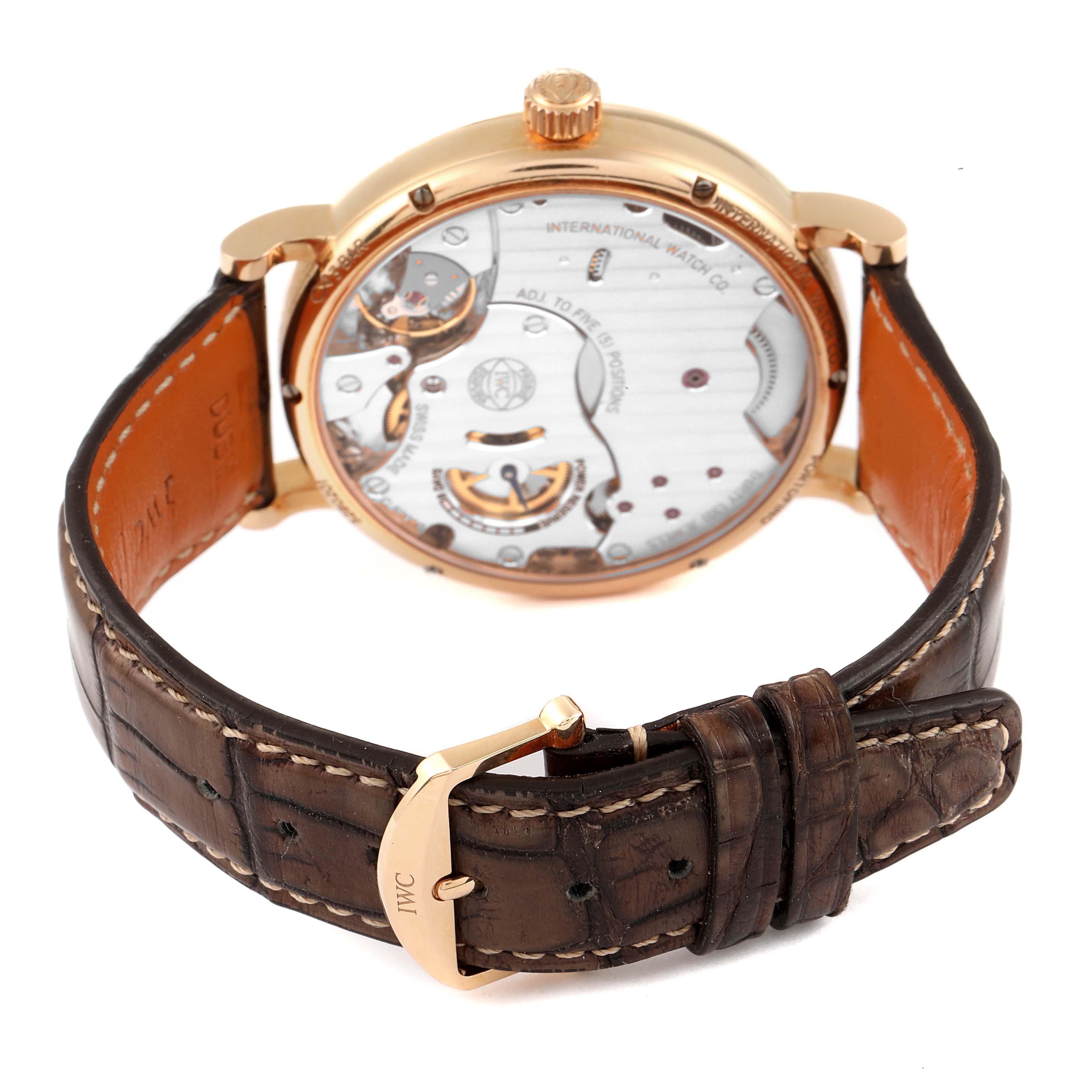 The image shows the rear view of the IWC Portofino IW511101 Men's Rose Gold Silver Dial IW511101 Men's Rose Gold Silver Dial watch, featuring its open case back and leather strap with an IWC buckle.