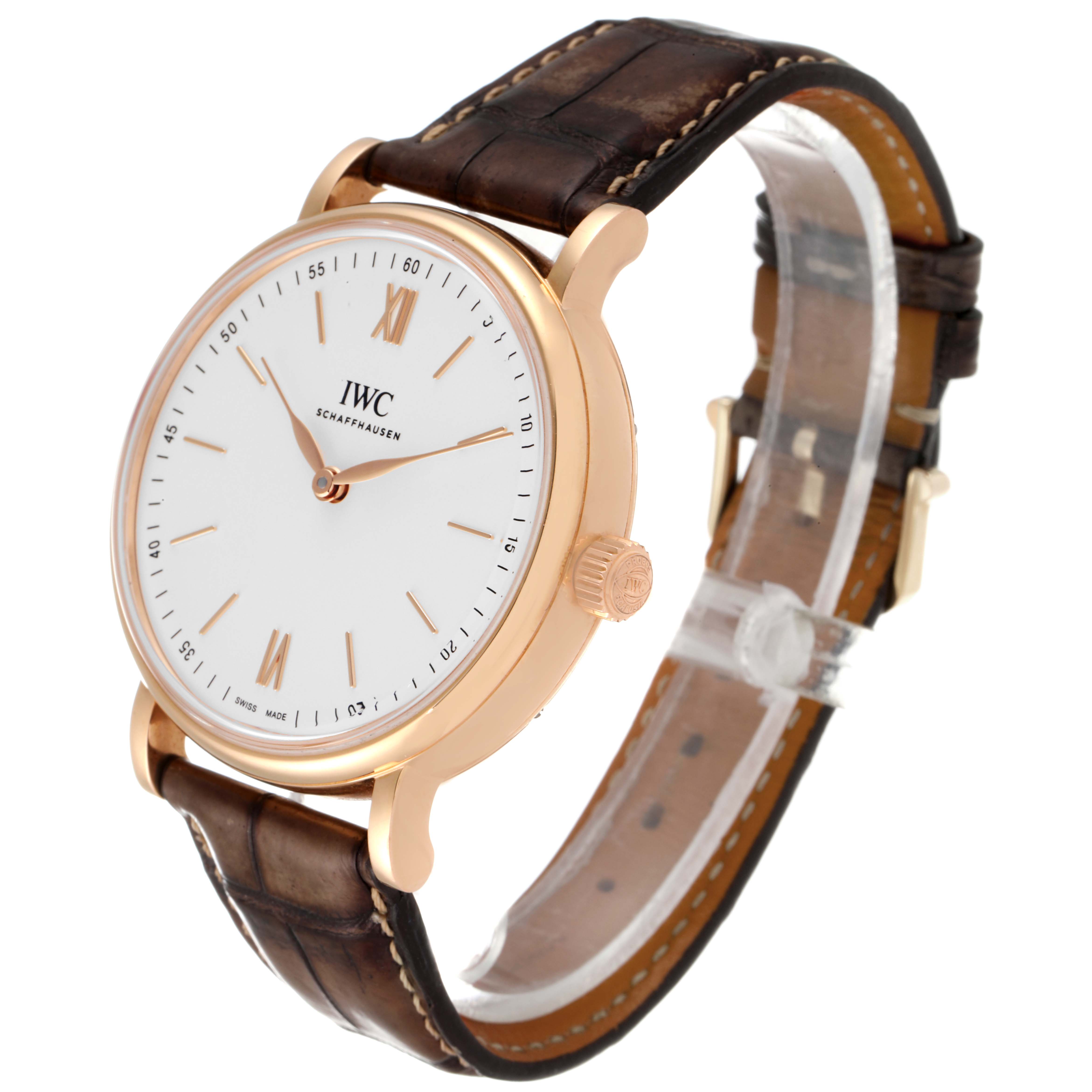 This image shows an angled view of an IWC Portofino IW511101 Men's Rose Gold Silver Dial IW511101 Men's Rose Gold Silver Dial watch, highlighting the face, leather strap, and crown.