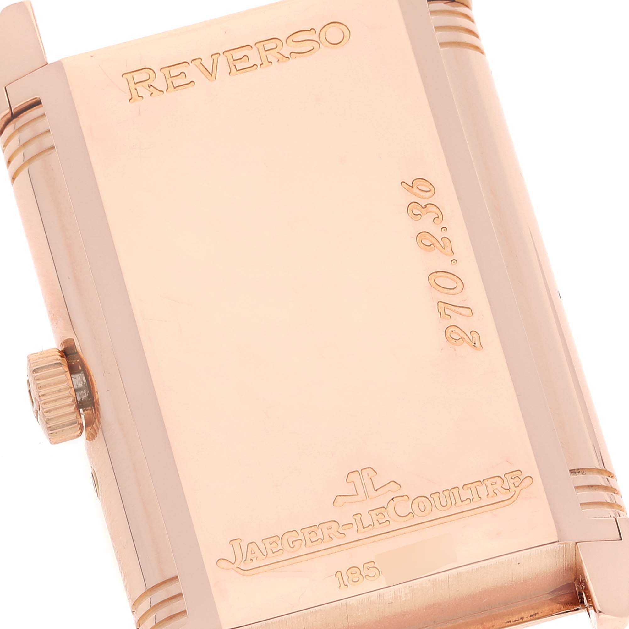 The image shows the back of a Jaeger-LeCoultre Reverso watch, highlighting the flat case and engraved details.