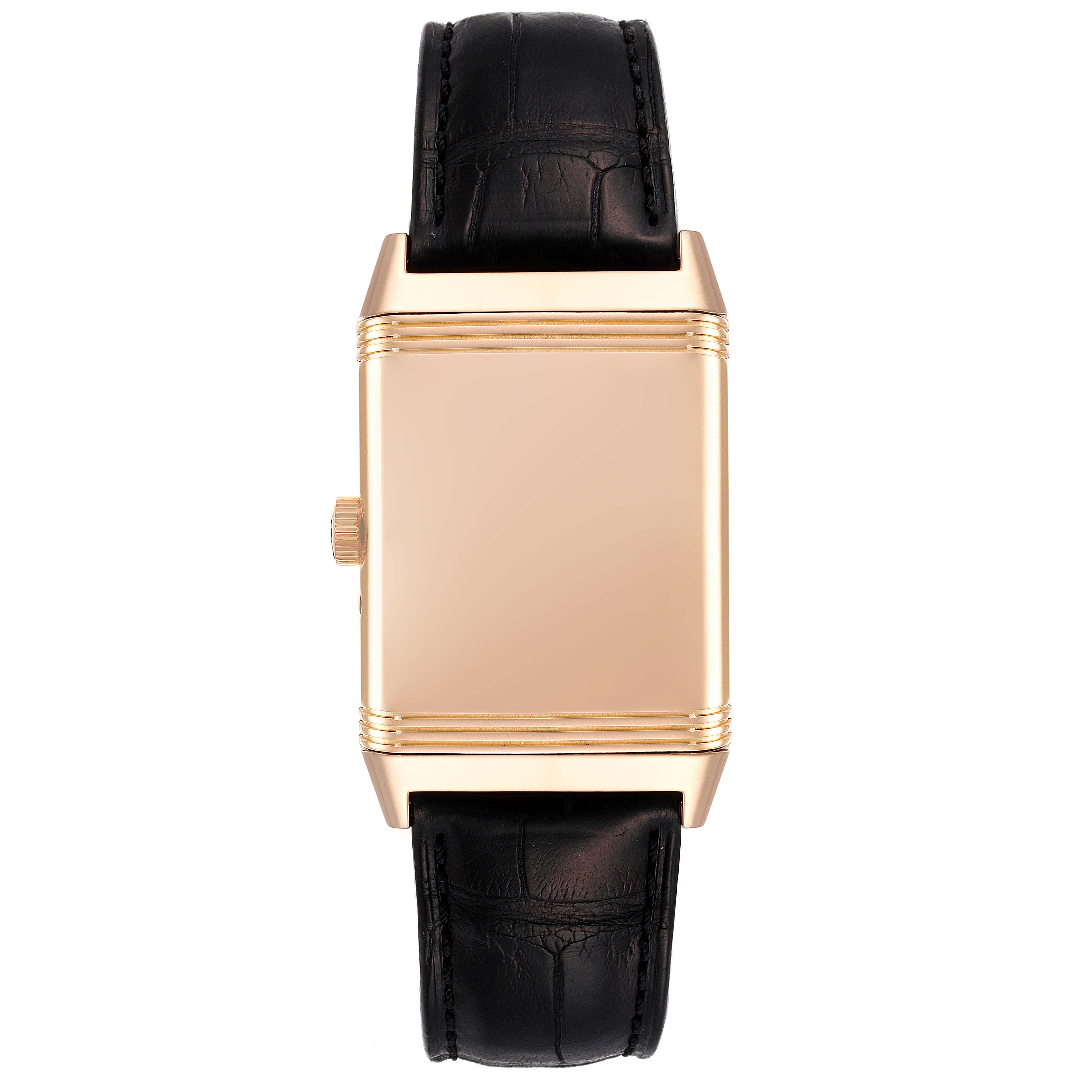 The image shows a front view of a Jaeger-LeCoultre Reverso watch with its distinctive reversible case and black leather strap.