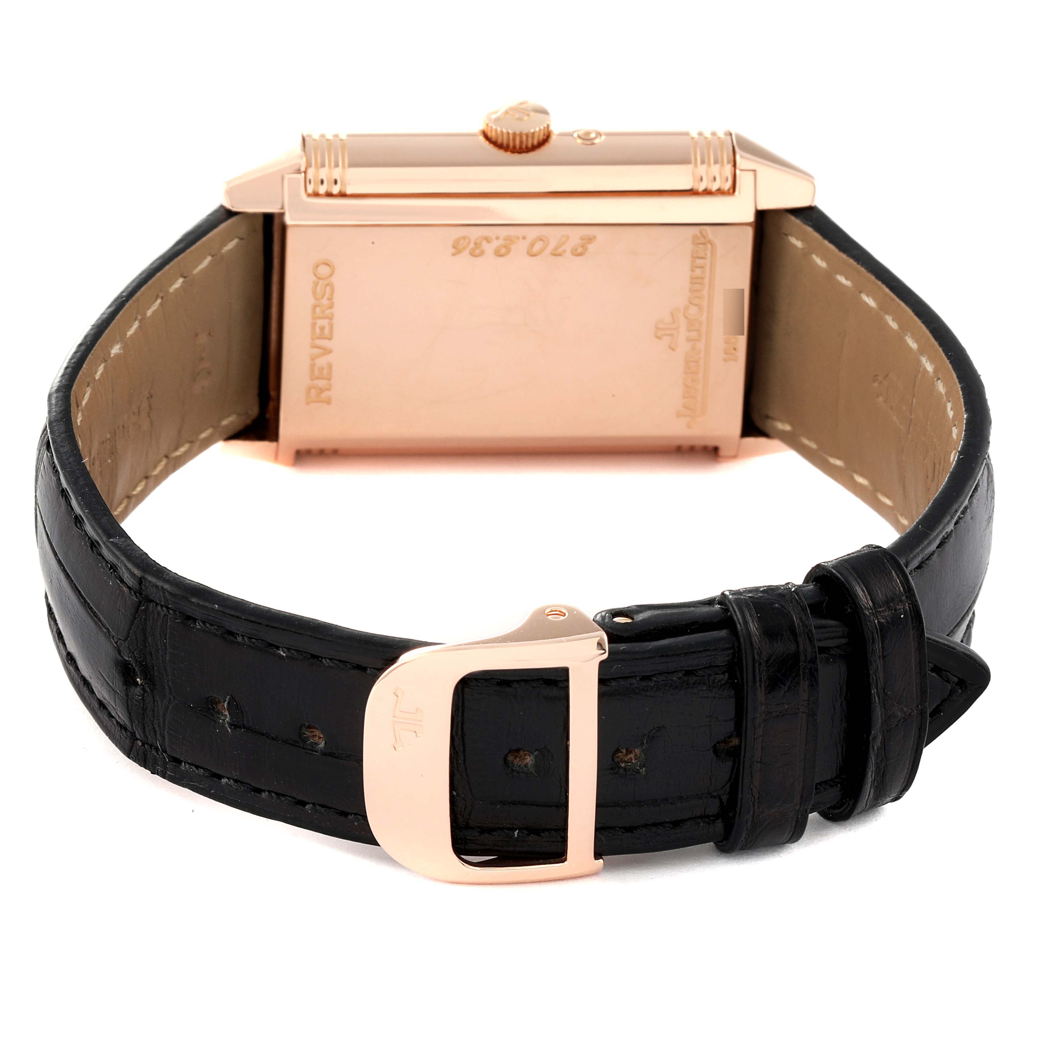 The image shows the back view of the Jaeger-LeCoultre Reverso watch with a focus on the case and black leather strap.