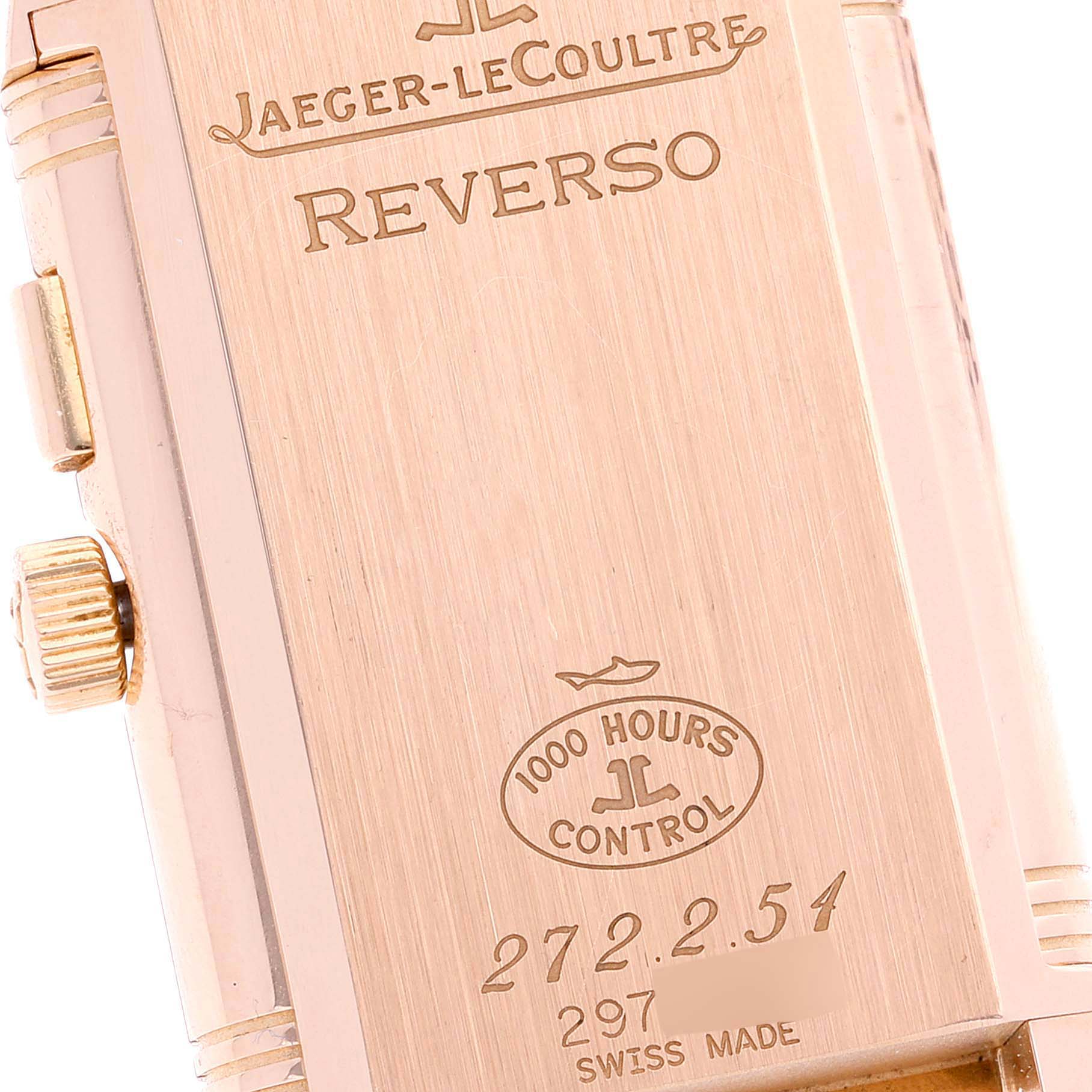 The image shows the back case of a Jaeger LeCoultre Reverso Q2712410 Men's Rose Gold Silver Dial Q2712410 Men's Rose Gold Silver Dial watch, highlighting the crown and engravings.