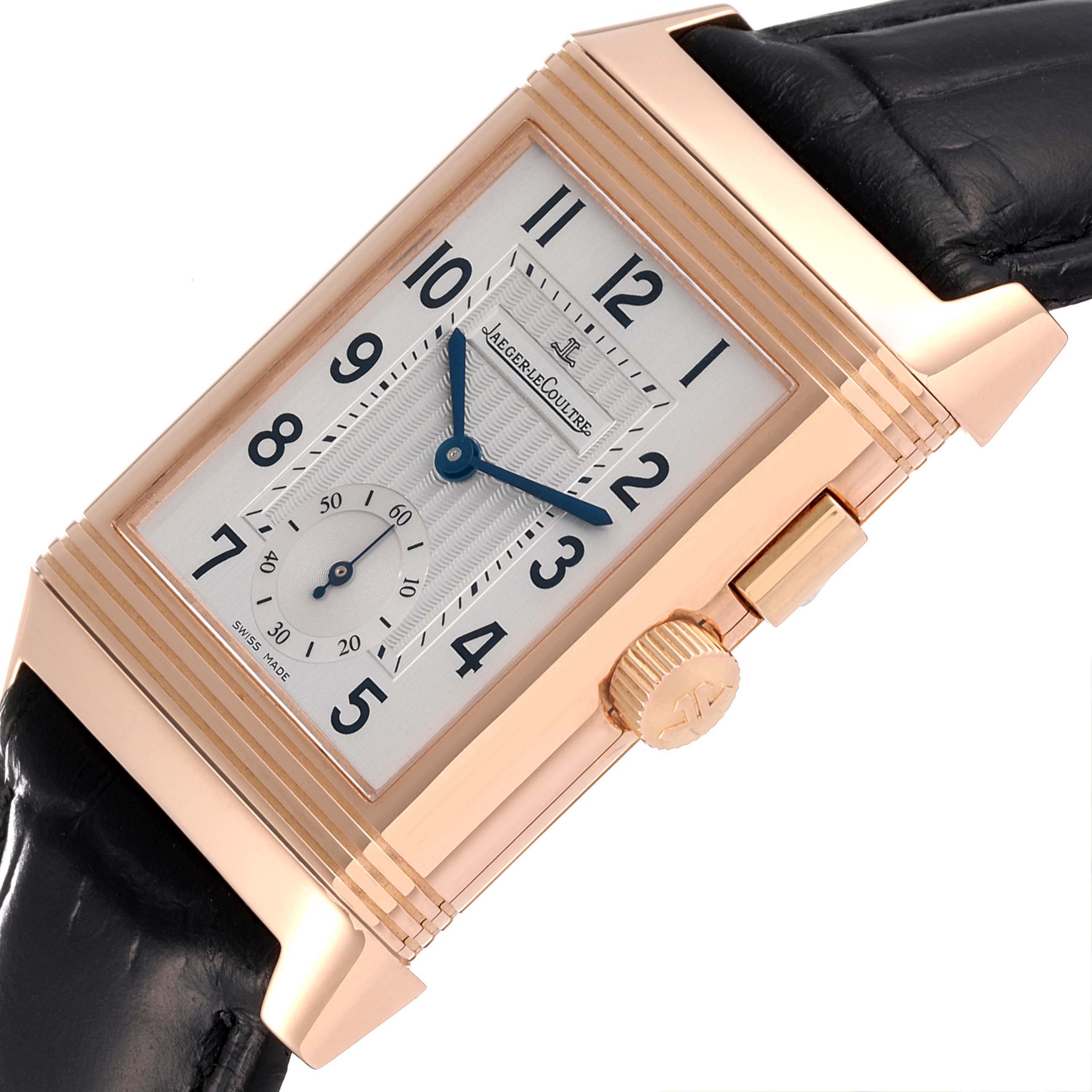 The image shows a close-up of the Jaeger-LeCoultre Reverso watch, featuring its dial, crown, and part of the black leather strap.