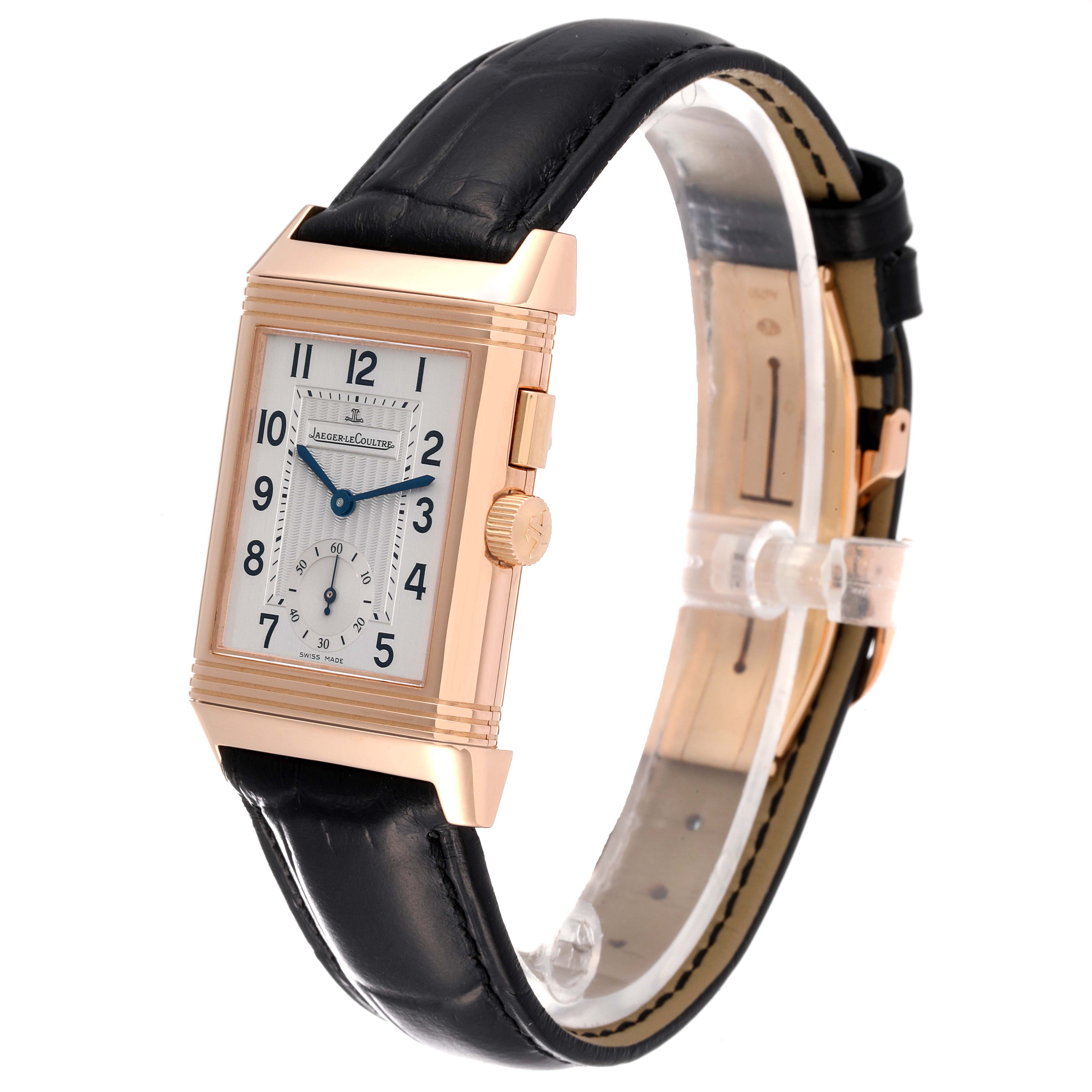 The image shows a side angle of the Jaeger LeCoultre Reverso Q2712410 Men's Rose Gold Silver Dial Q2712410 Men's Rose Gold Silver Dial watch with its face, crown, and black leather strap visible.
