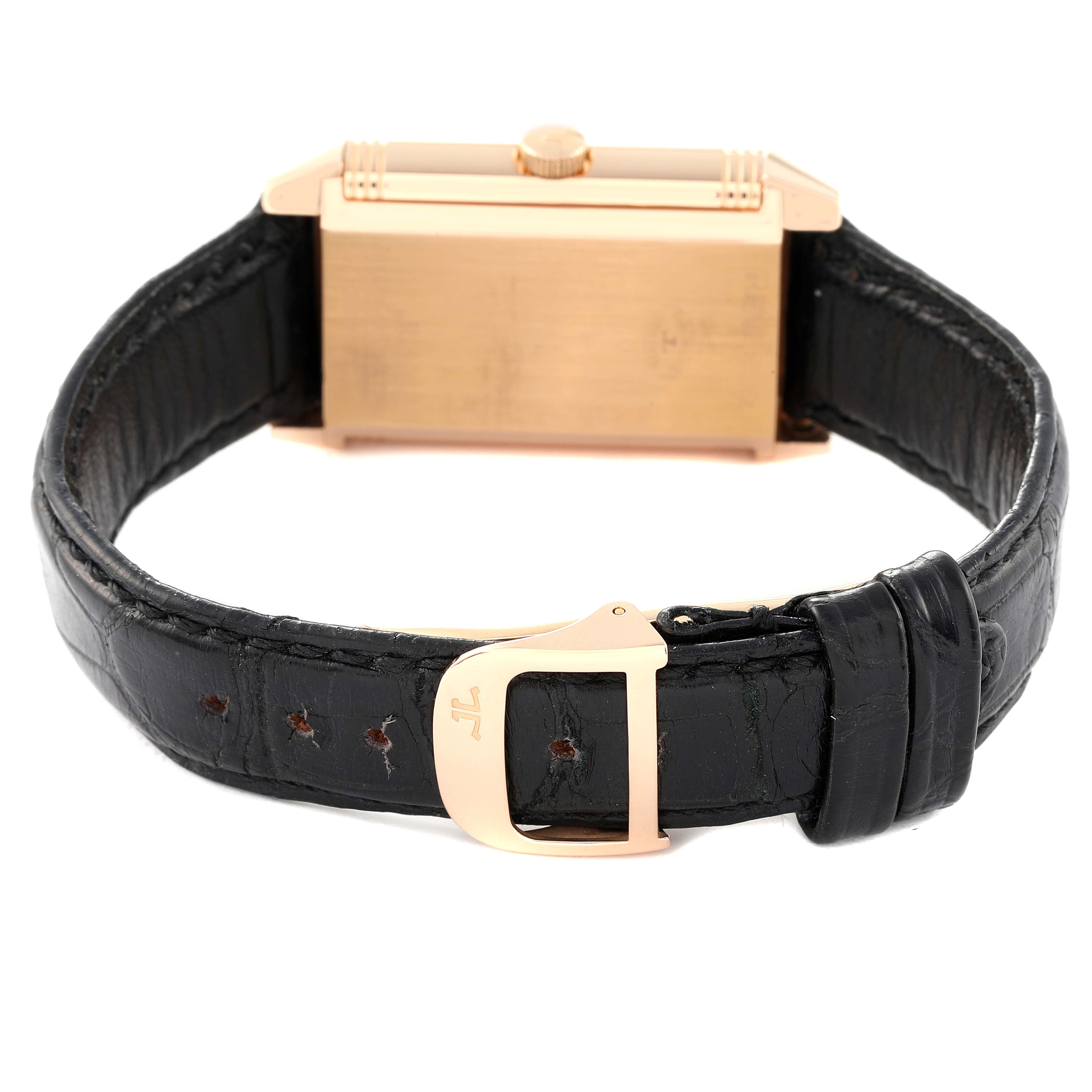 This image shows the rear view of a Jaeger-LeCoultre Reverso watch, highlighting its case, crown, and leather strap with deployant clasp.