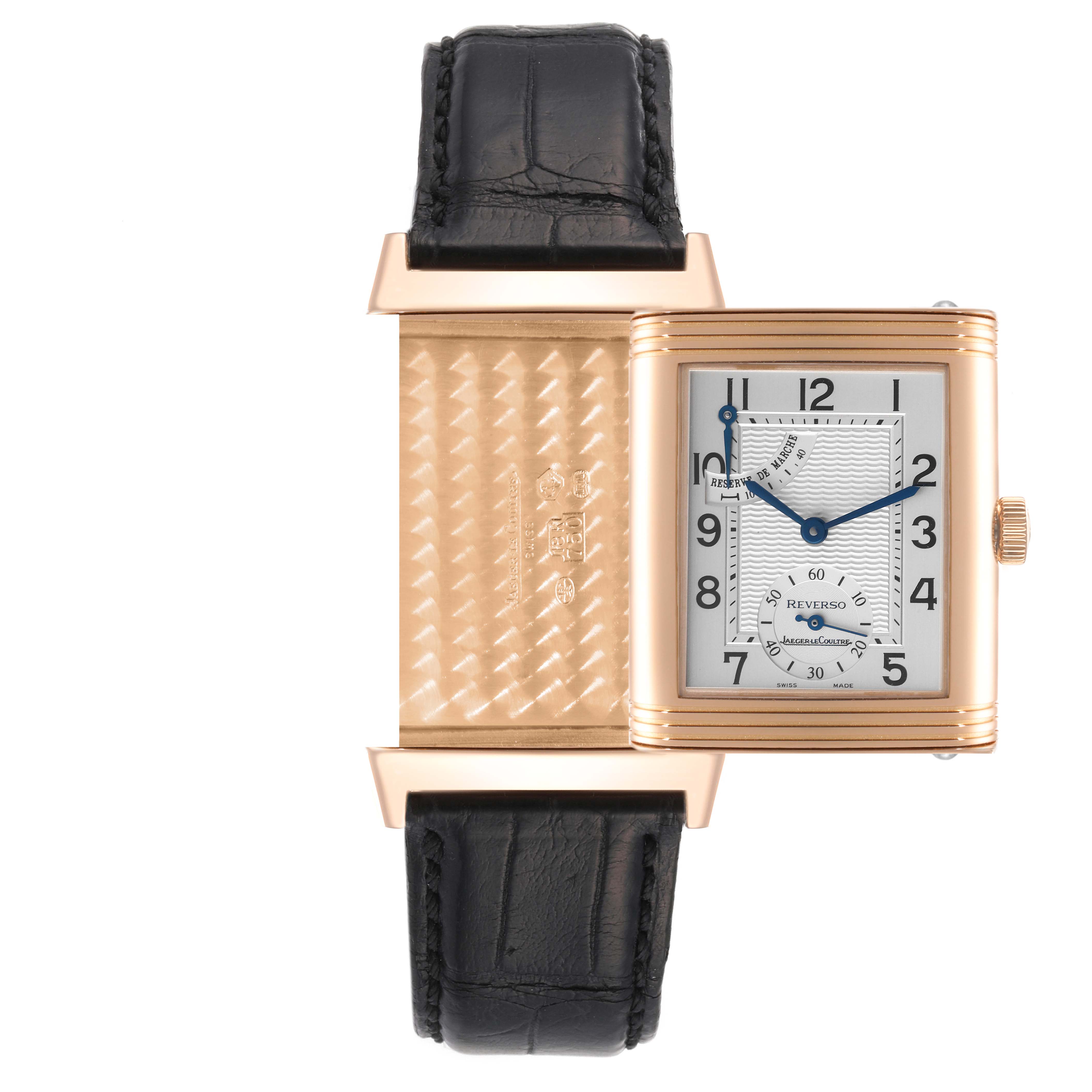 The image displays a Jaeger-LeCoultre Reverso watch with the case swiveled to show both the dial and the engraved backside.