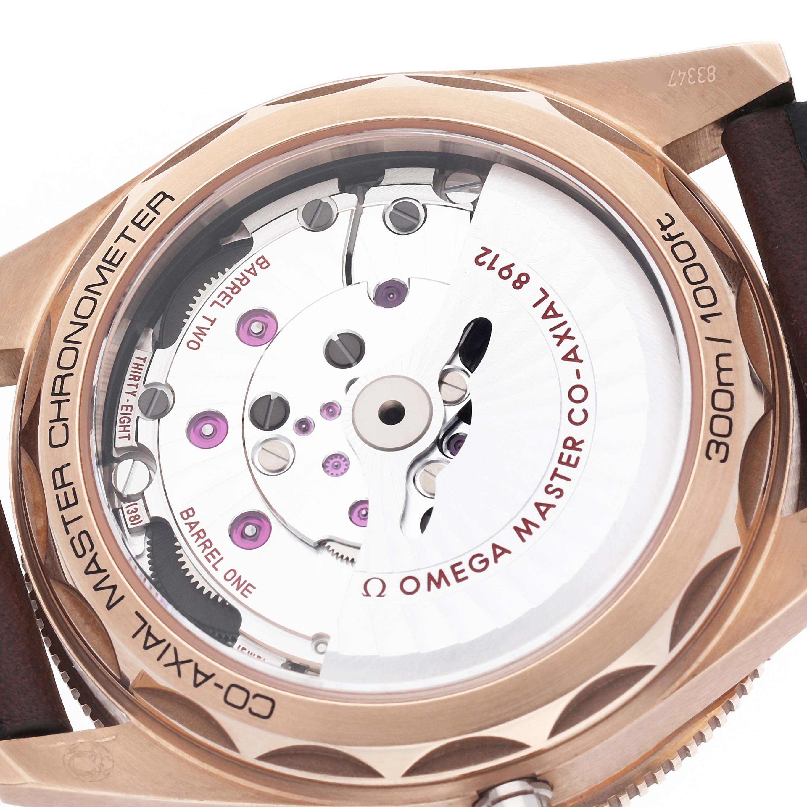 The image shows the back view of an Omega Seamaster 234.92.41.21.10.001 Men's Bronze Brown Dial, highlighting the movement and inscriptions on the case.