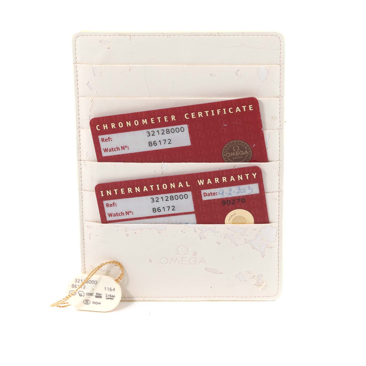 The image shows an Omega Speedmaster 3212.80.00 Men's Stainless Steel Blue Dial 3212.80.00 Men's Stainless Steel Blue Dial's chronometer certificate, international warranty cards, and two tags in a white cardholder.