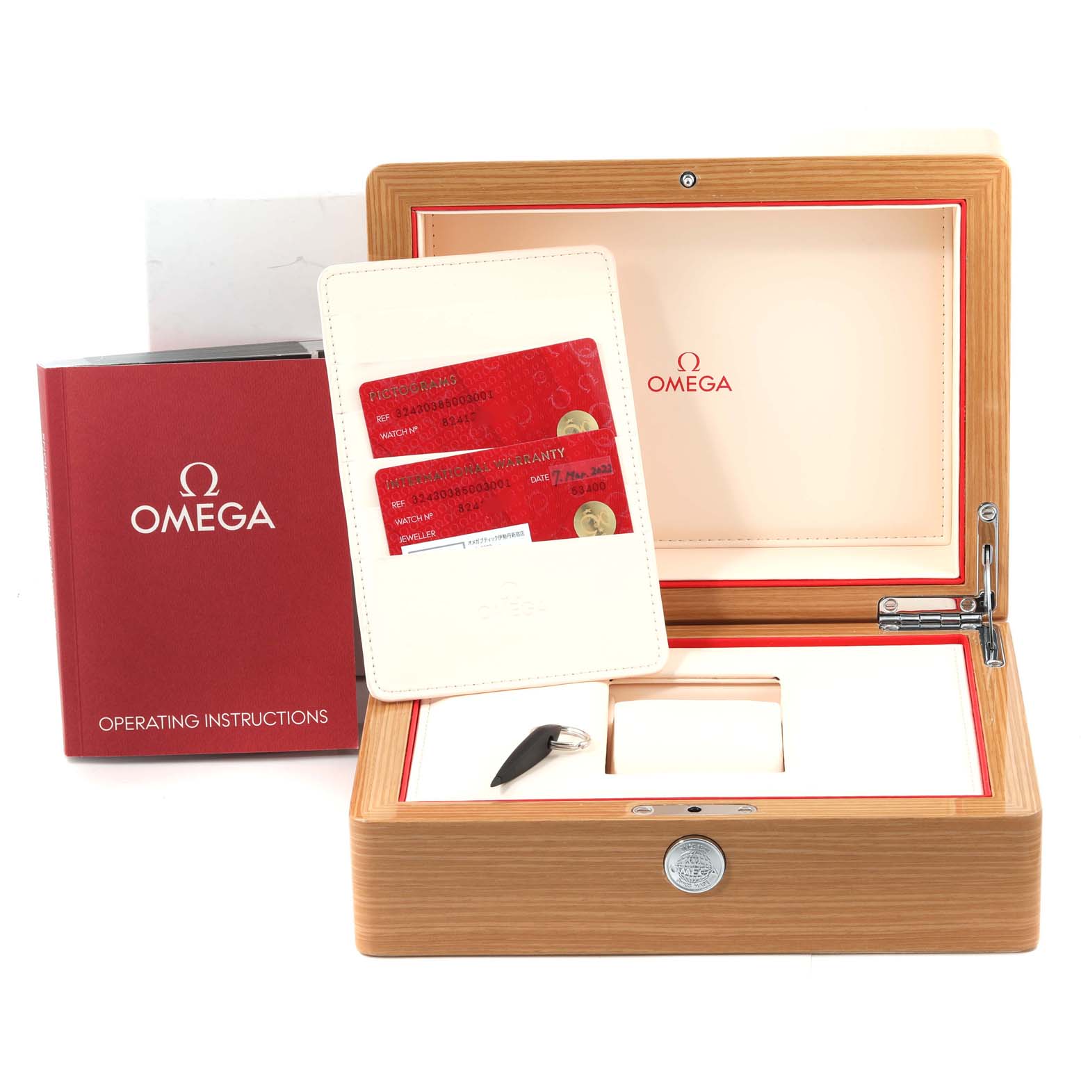 The image shows an Omega Speedmaster 324.30.38.50.03.001 Men's Stainless Steel Blue Dial 324.30.38.50.03.001 Men's Stainless Steel Blue Dial watch box, warranty cards, and operating instructions from a front angle.